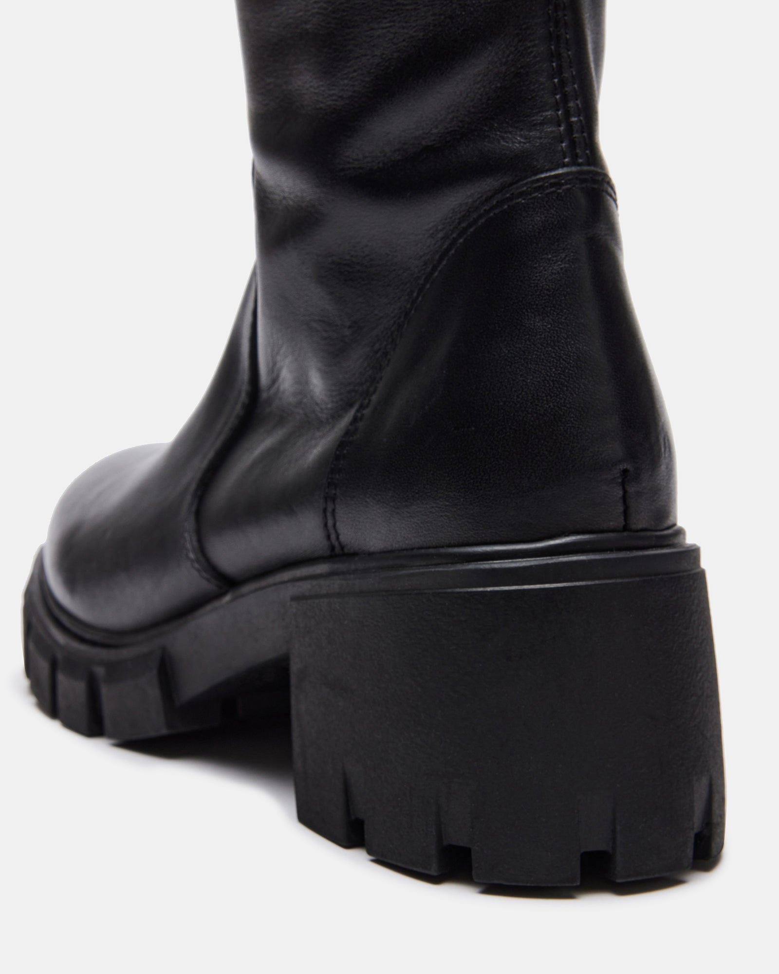 HARTH knee boots on foot, showcasing block heel