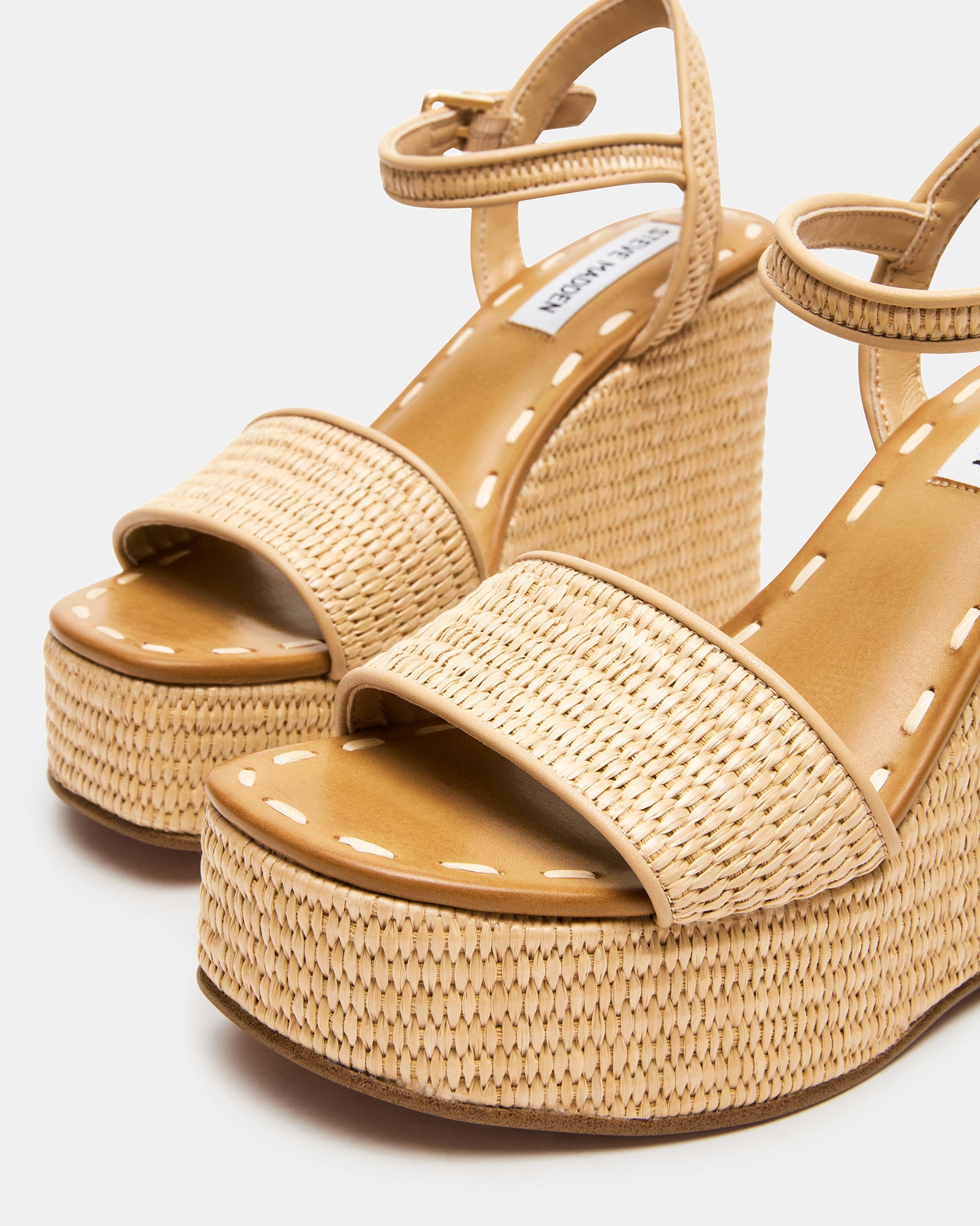 Haven raffia platform sandals on cobblestone street