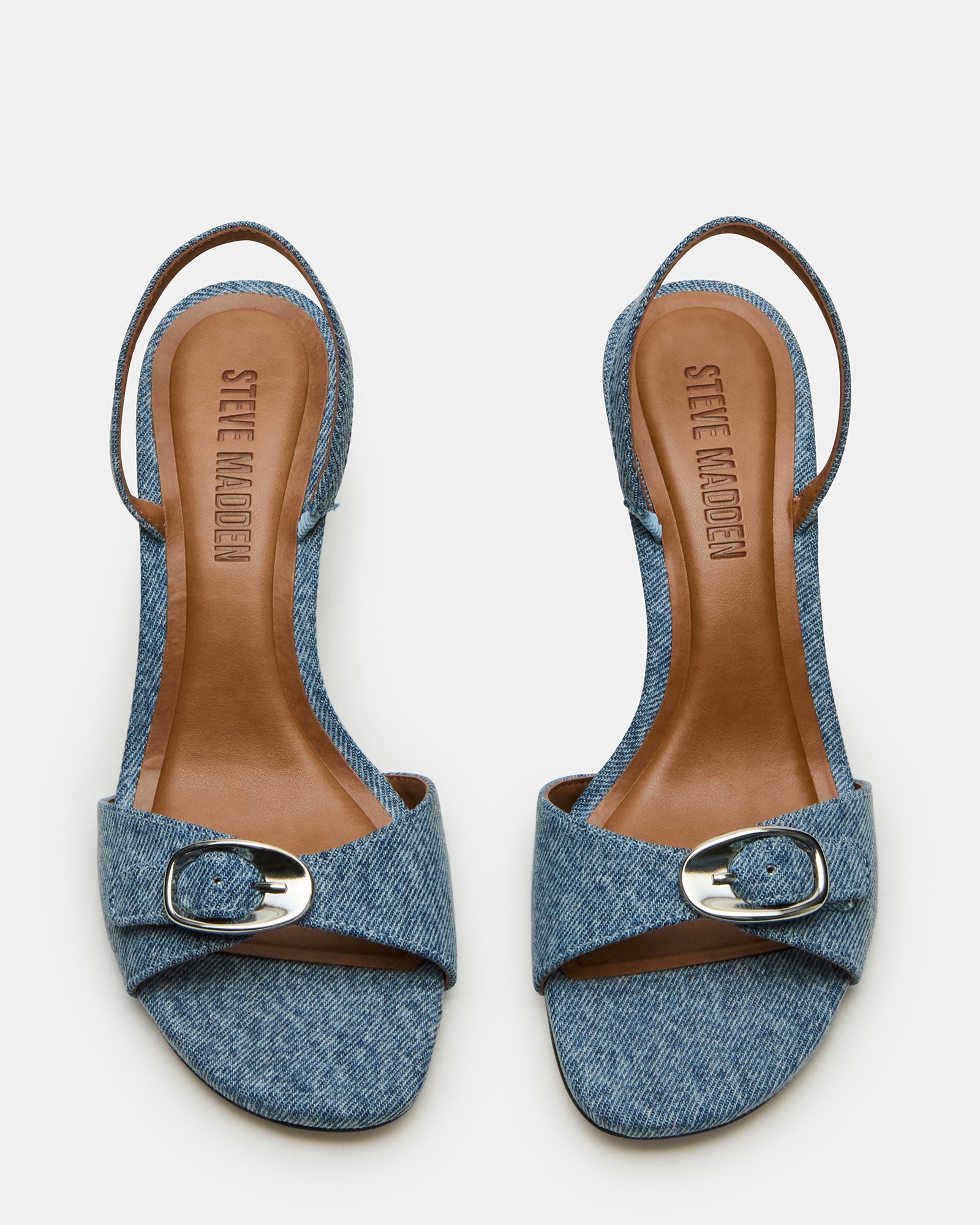 Close-up of square toe slingback heels in textured denim fabric on white background.