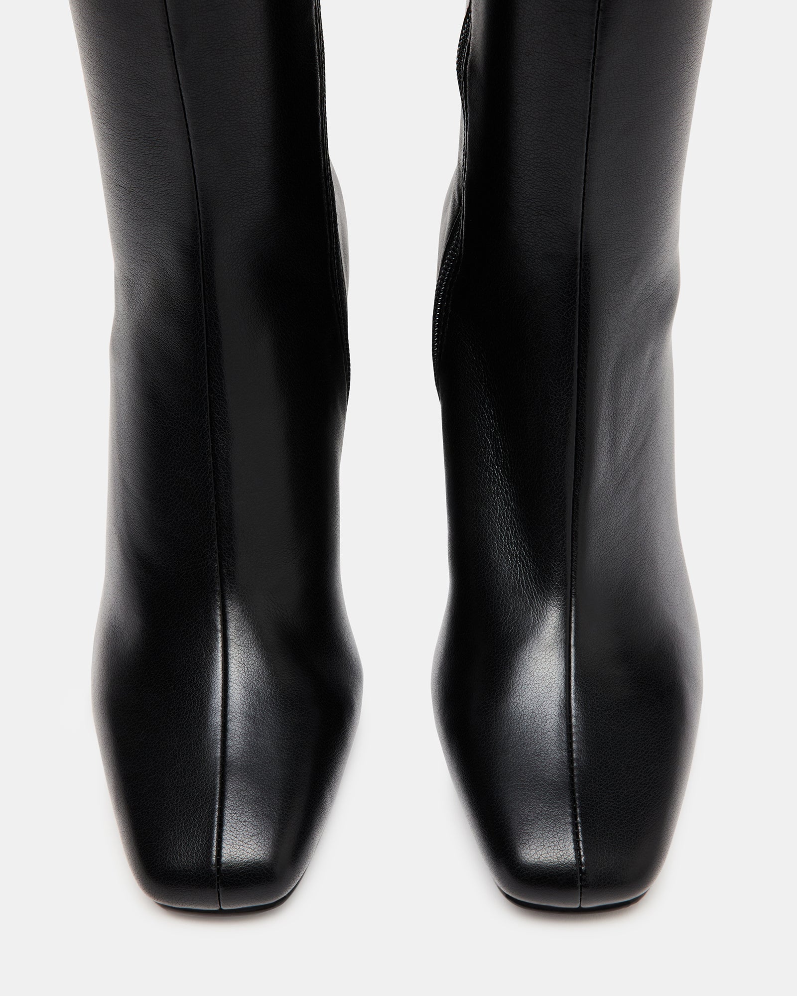 Side profile showcasing the square toe and calf-hugging silhouette of these knee boots.