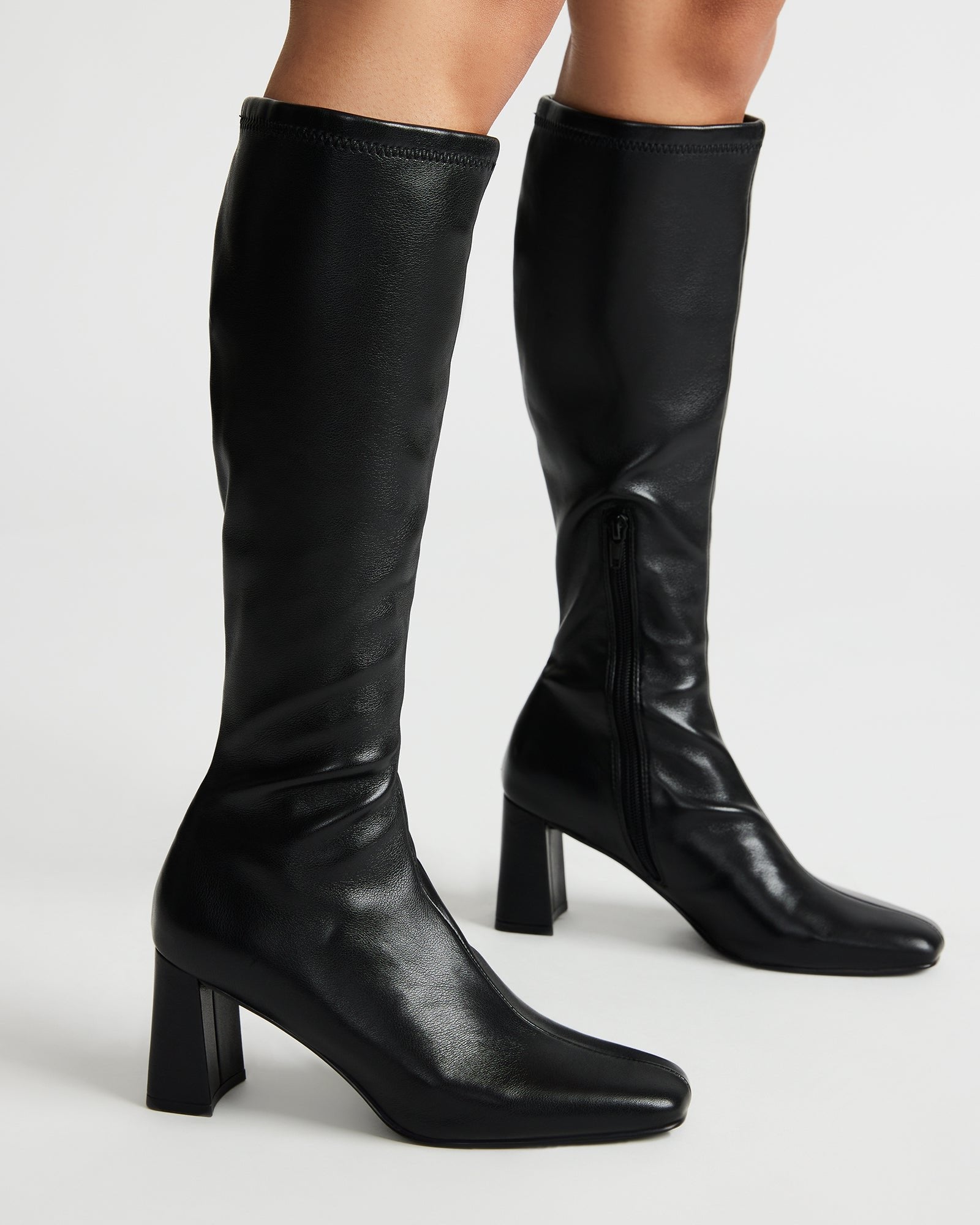 Side profile showcasing the square toe and calf-hugging silhouette of these knee boots.