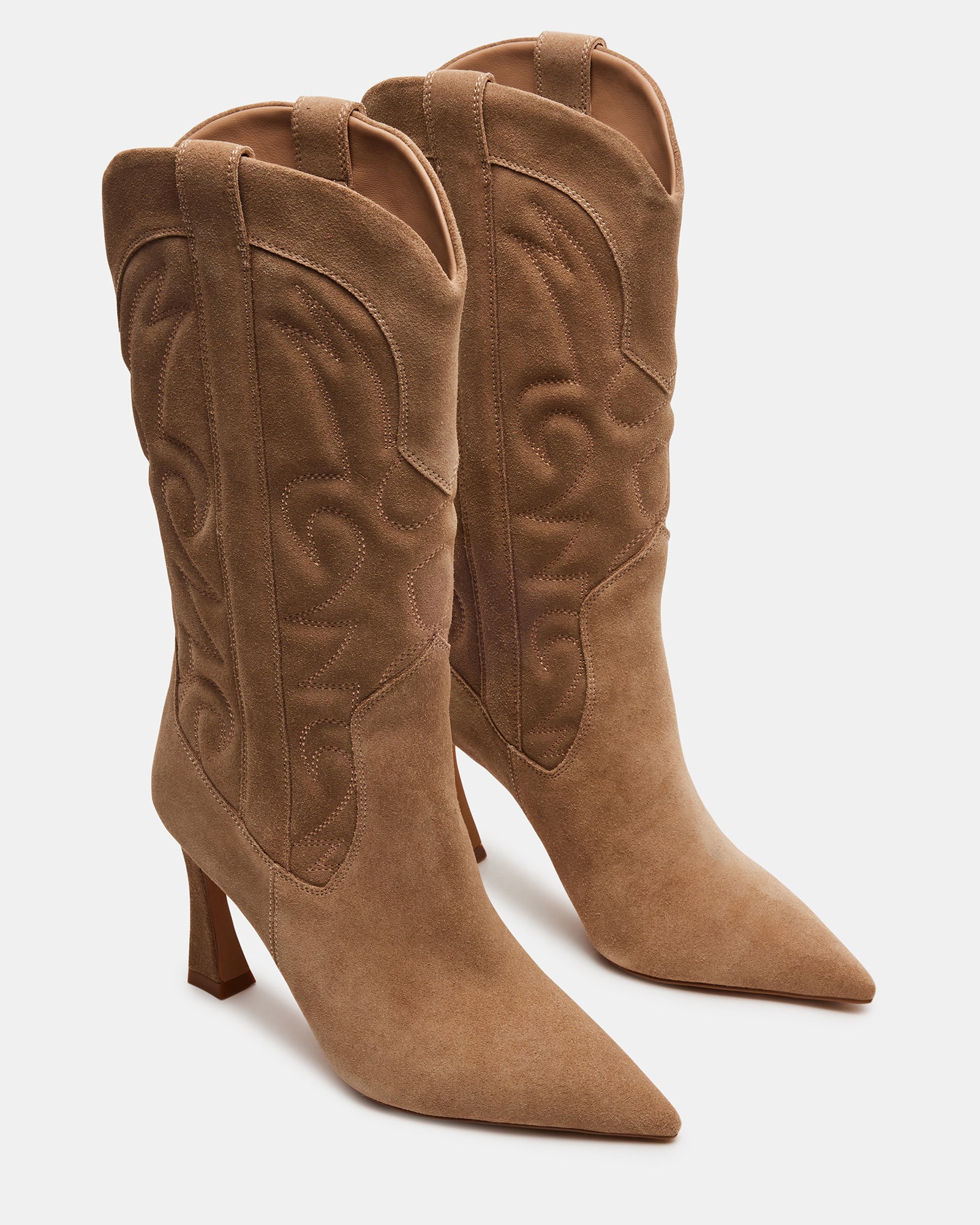 Front view of black western boots with pointed toe, styled against fall leaves