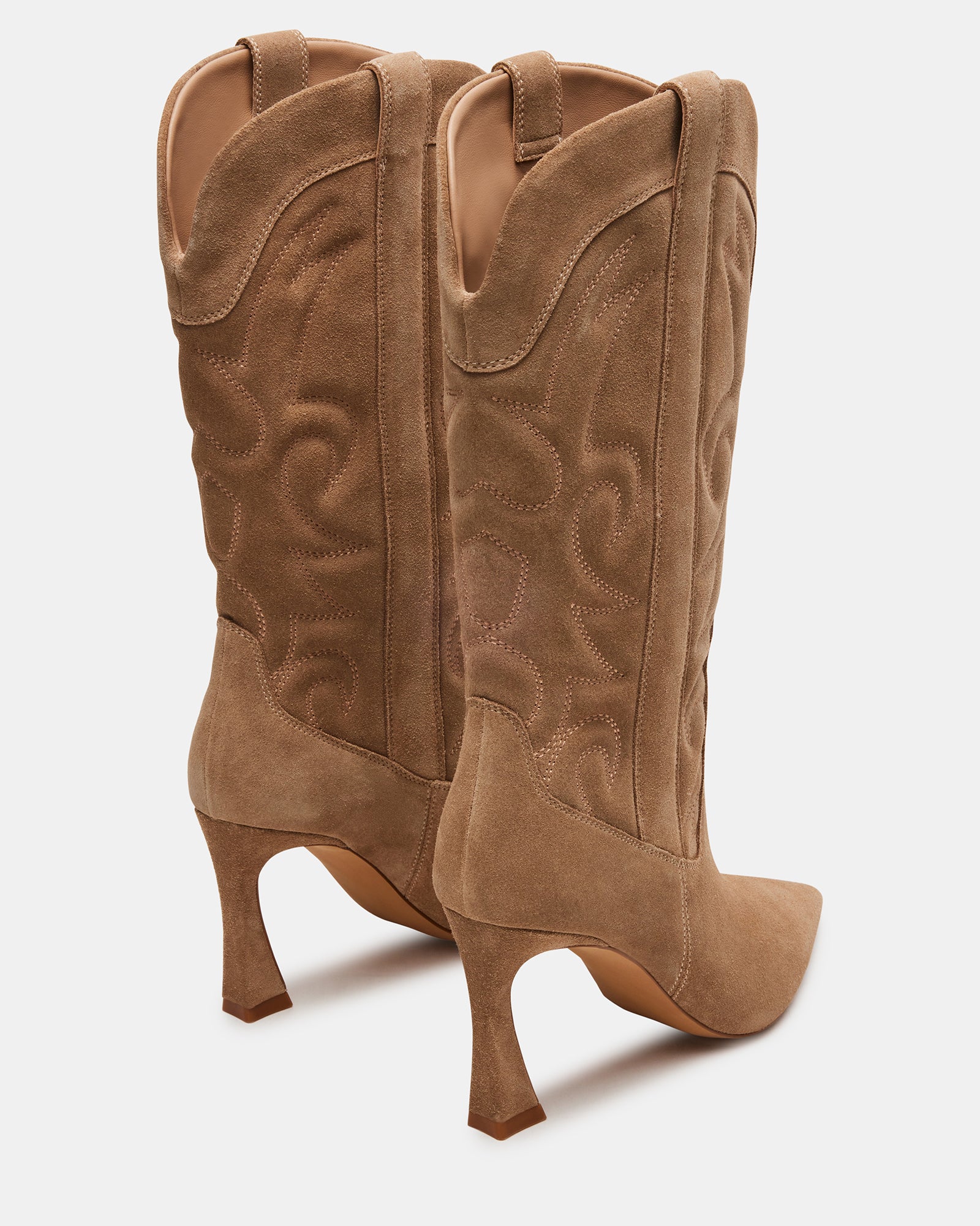 Front view of black western boots with pointed toe, styled against fall leaves