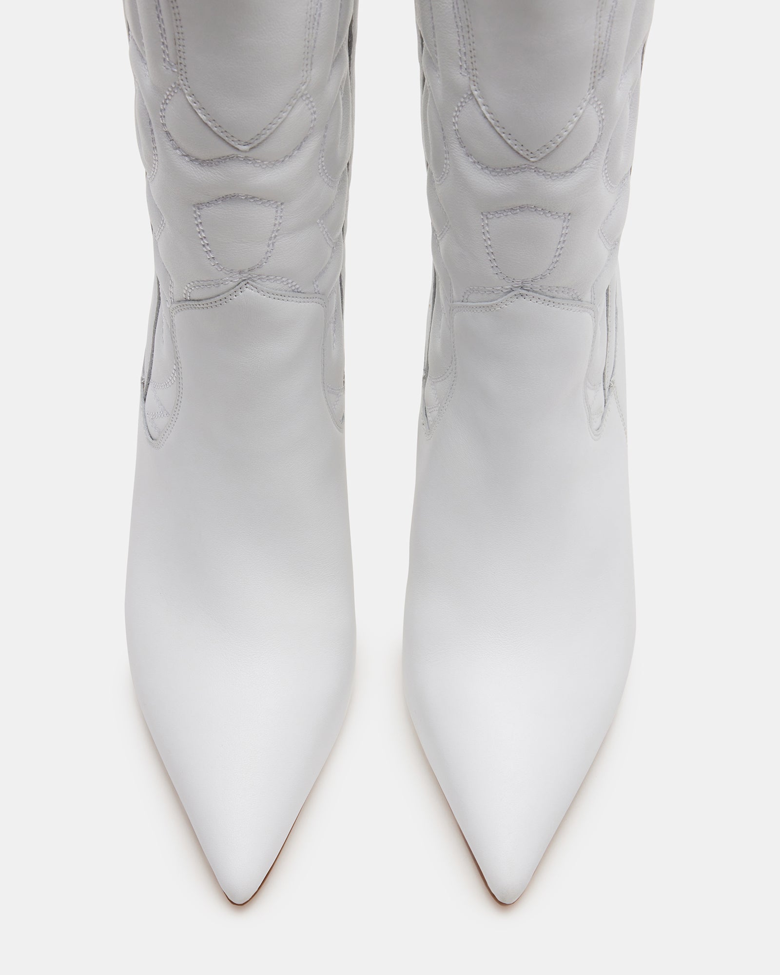 Close-up of the pointed toe design on white leather western boots