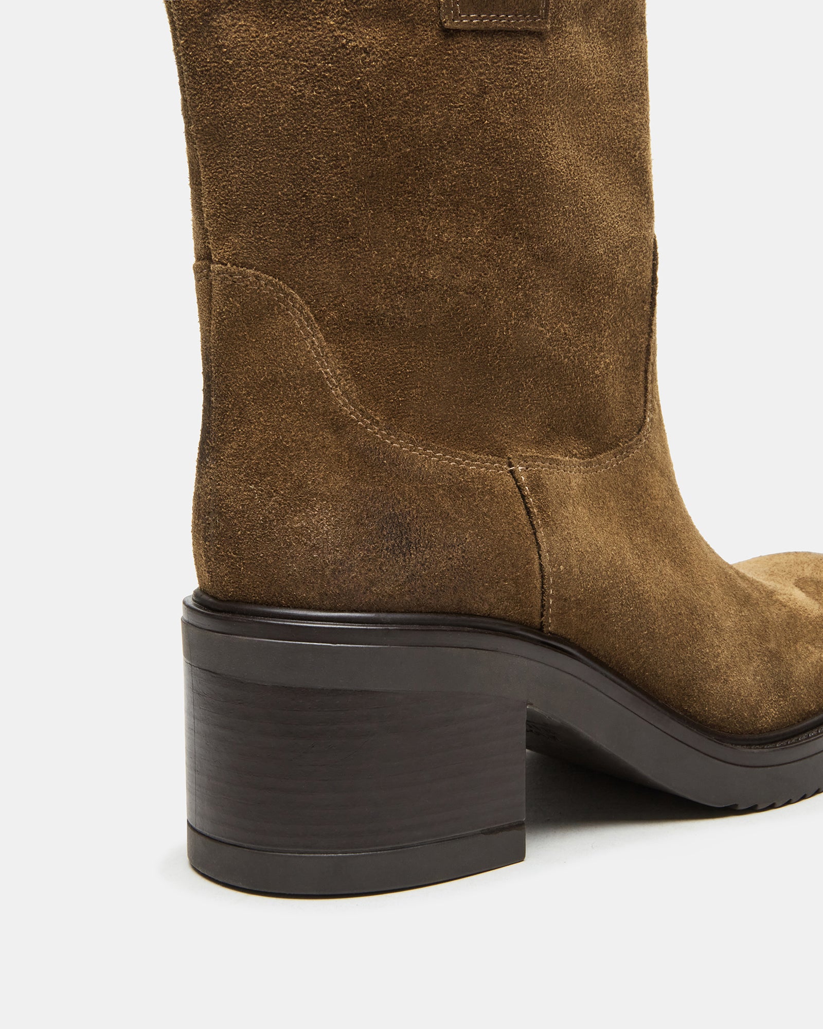 Lifestyle shot of womens ankle boots paired with layered winter wear