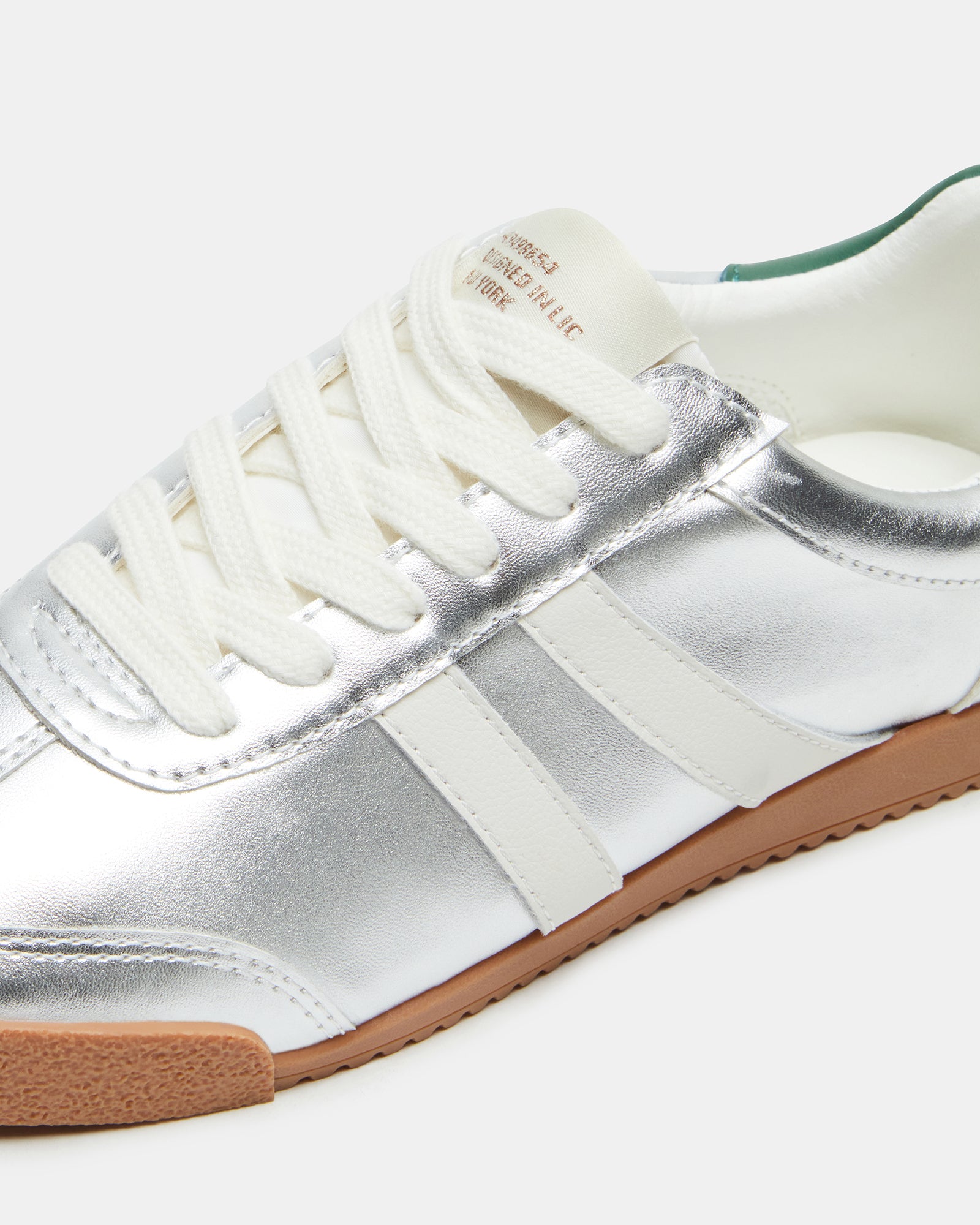 Side view of HUDSIN Silver Multi sneakers highlighting the low-top design and silver accents