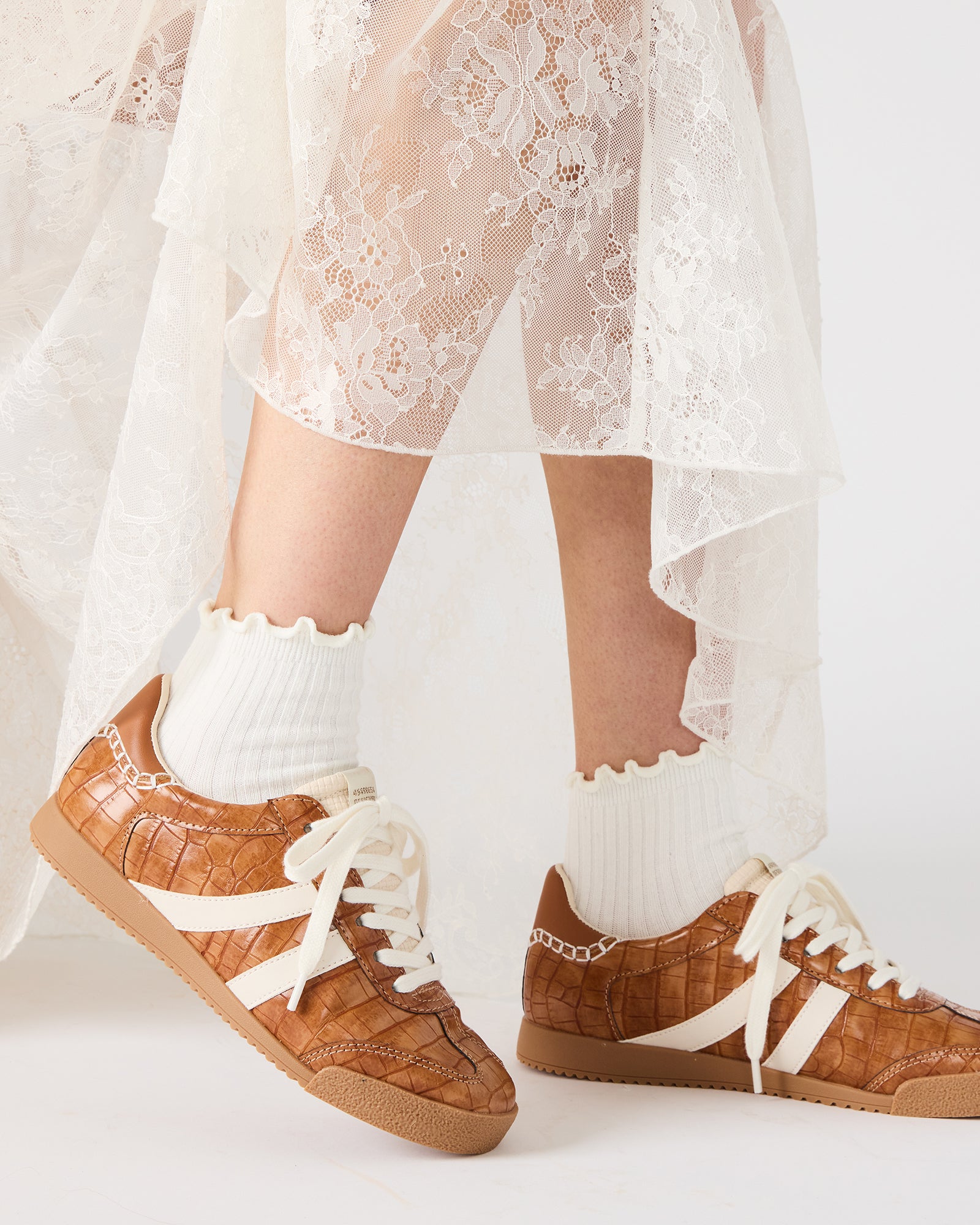 Mens low-top sneakers photographed with office-casual outfit for weekday use