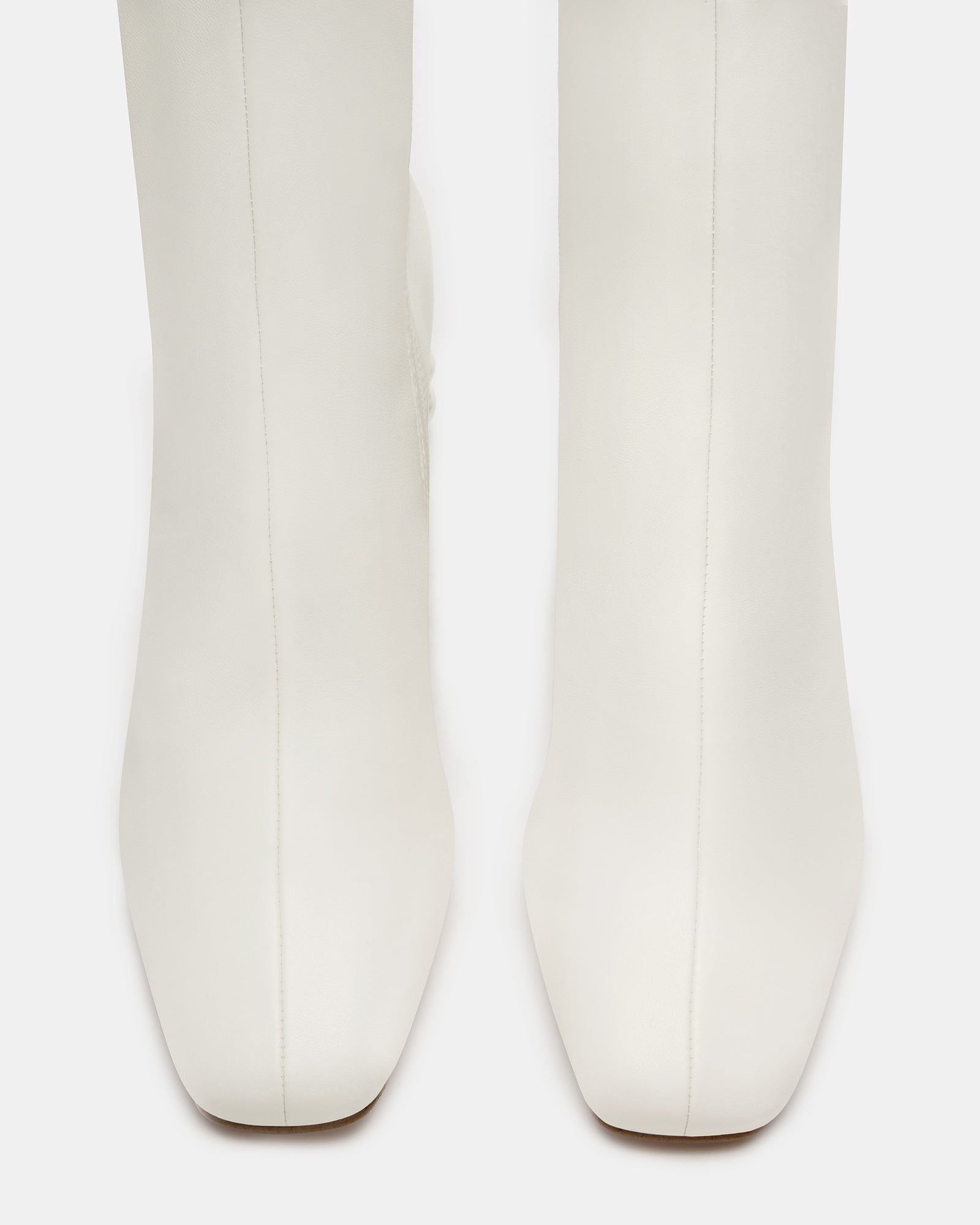 Close-up of the sleek design of black ankle boots with a chic touch.