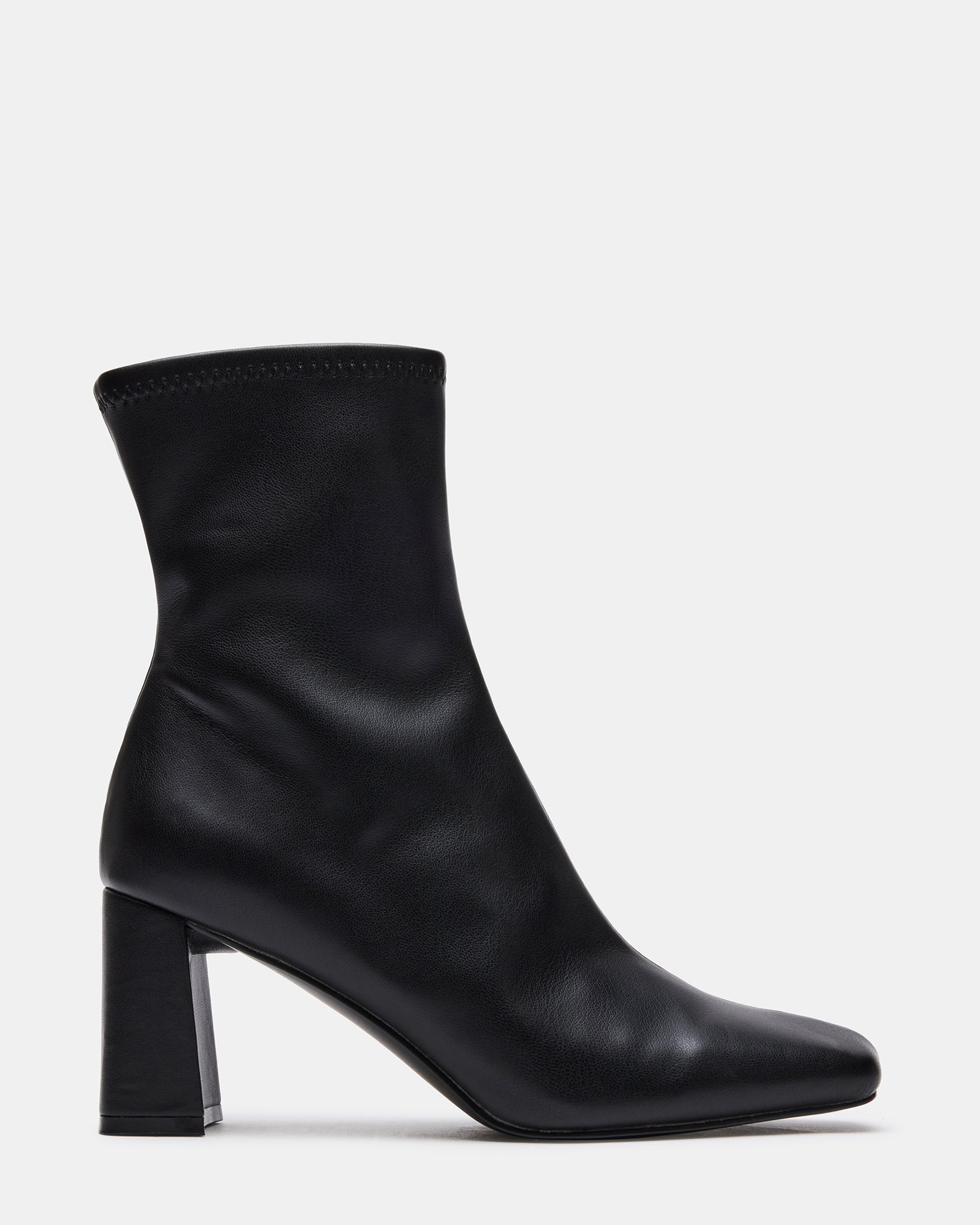 Side view of chic booties in black vegan leather, styled for fall outfits.
