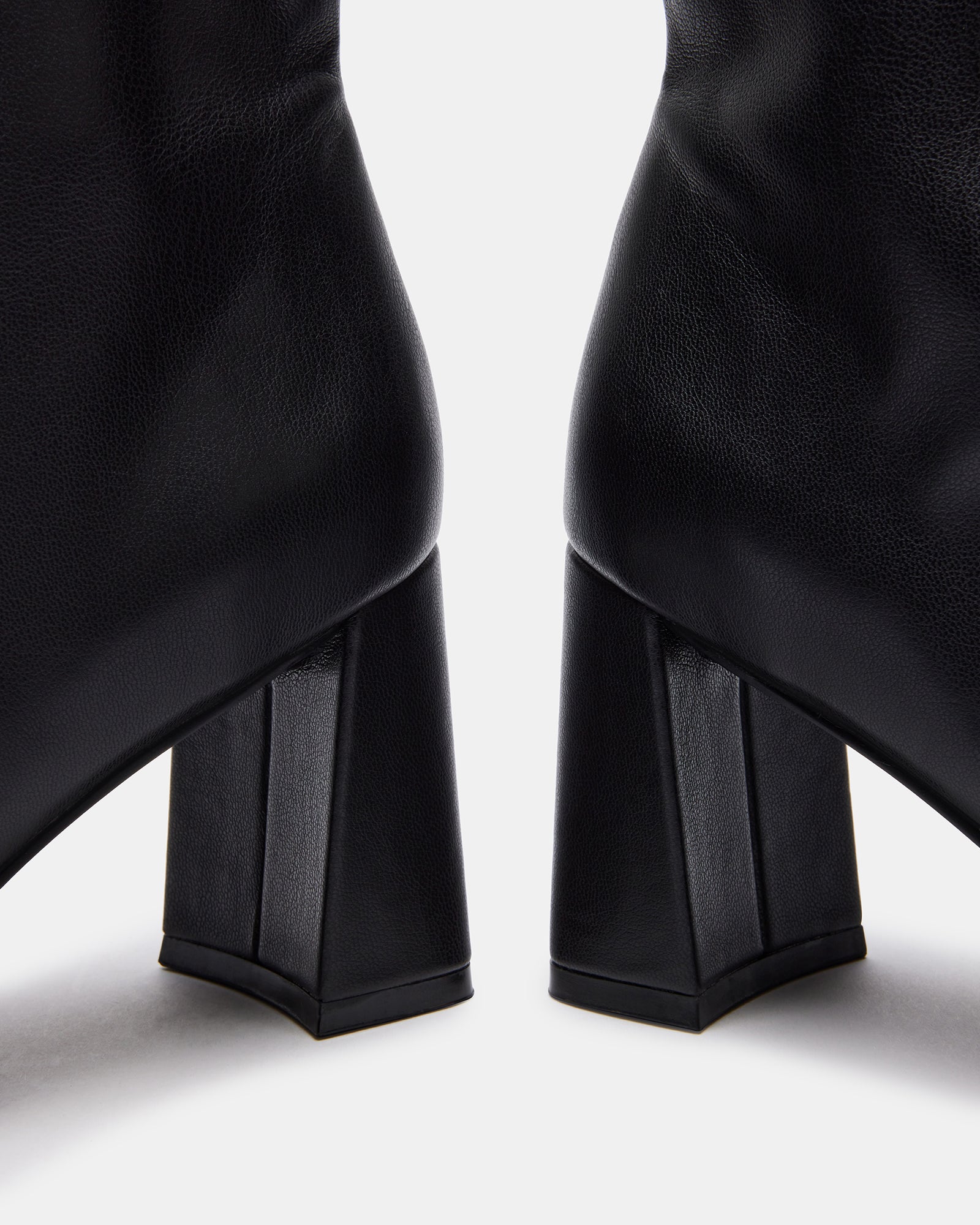 Side view of chic booties in black vegan leather, styled for fall outfits.
