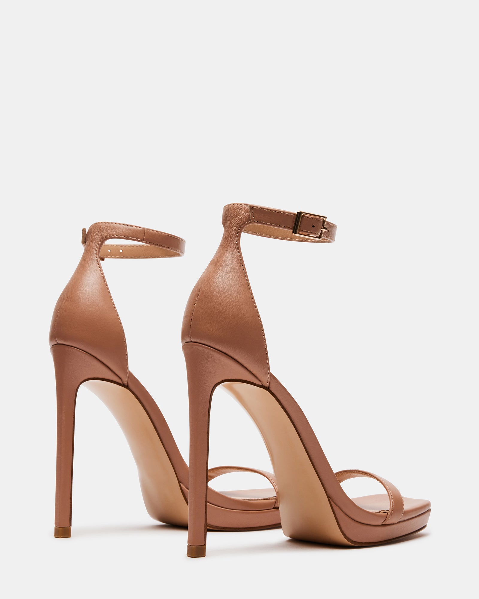 Close-up of square toe and ankle strap on brown leather sandals