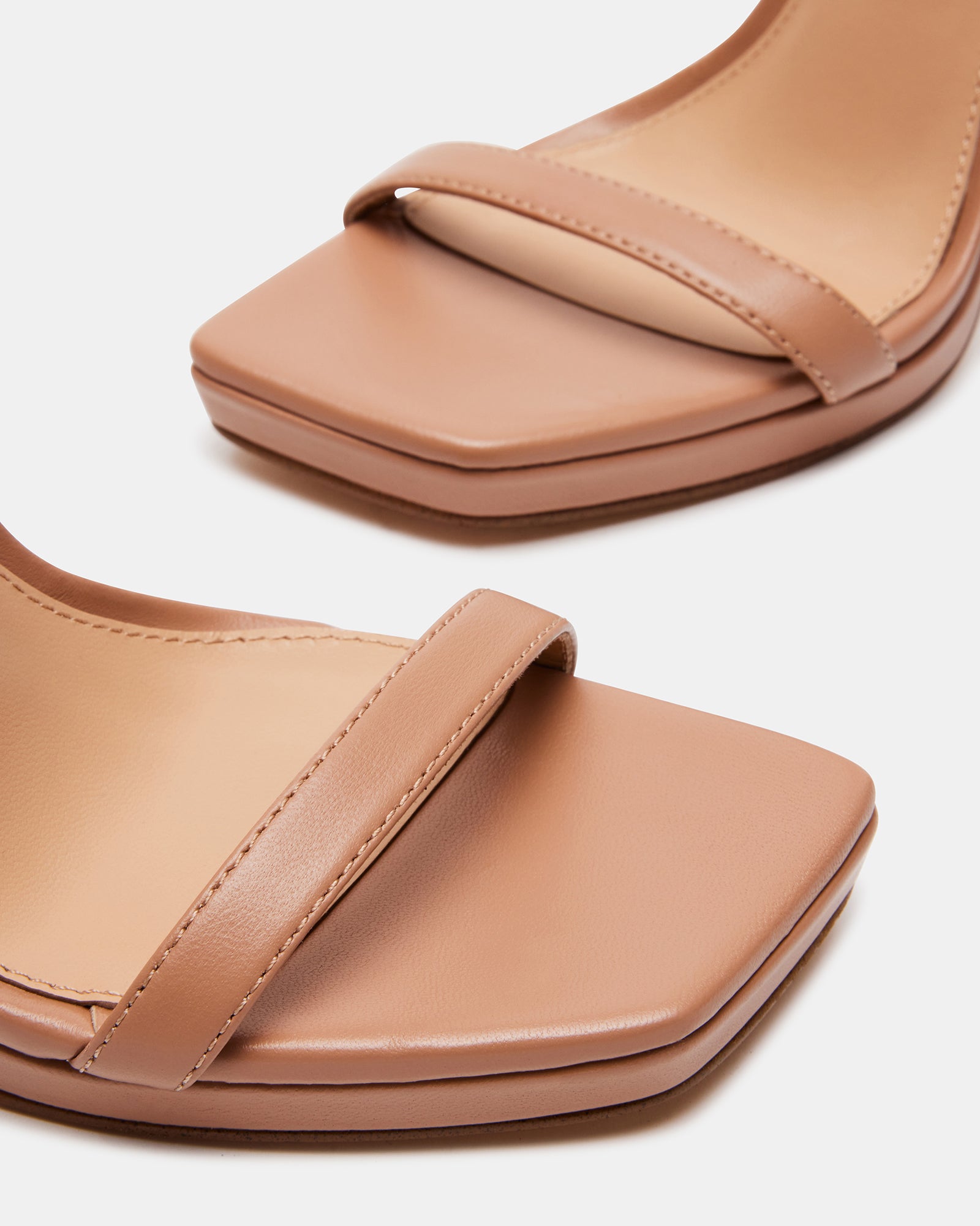 Tan leather dress sandals from side view showing stiletto heel