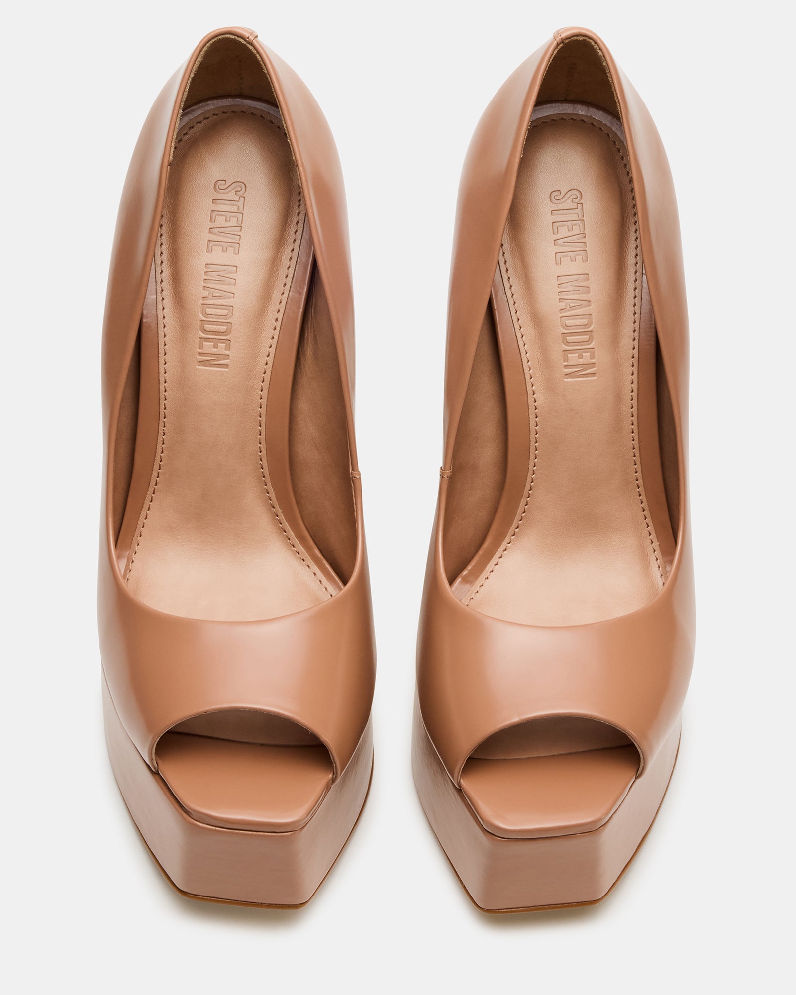 Side angle of blush stiletto heels showing platform height and square toe silhouette.