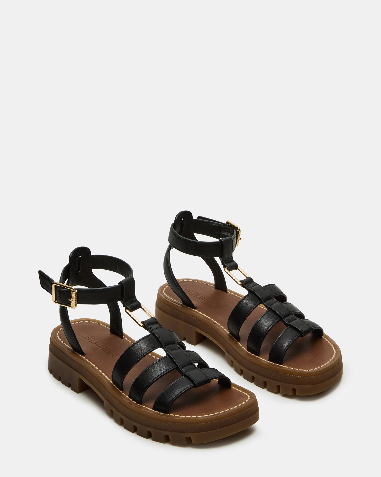 Side view of black leather sandals emphasizing the padded insole for comfort.