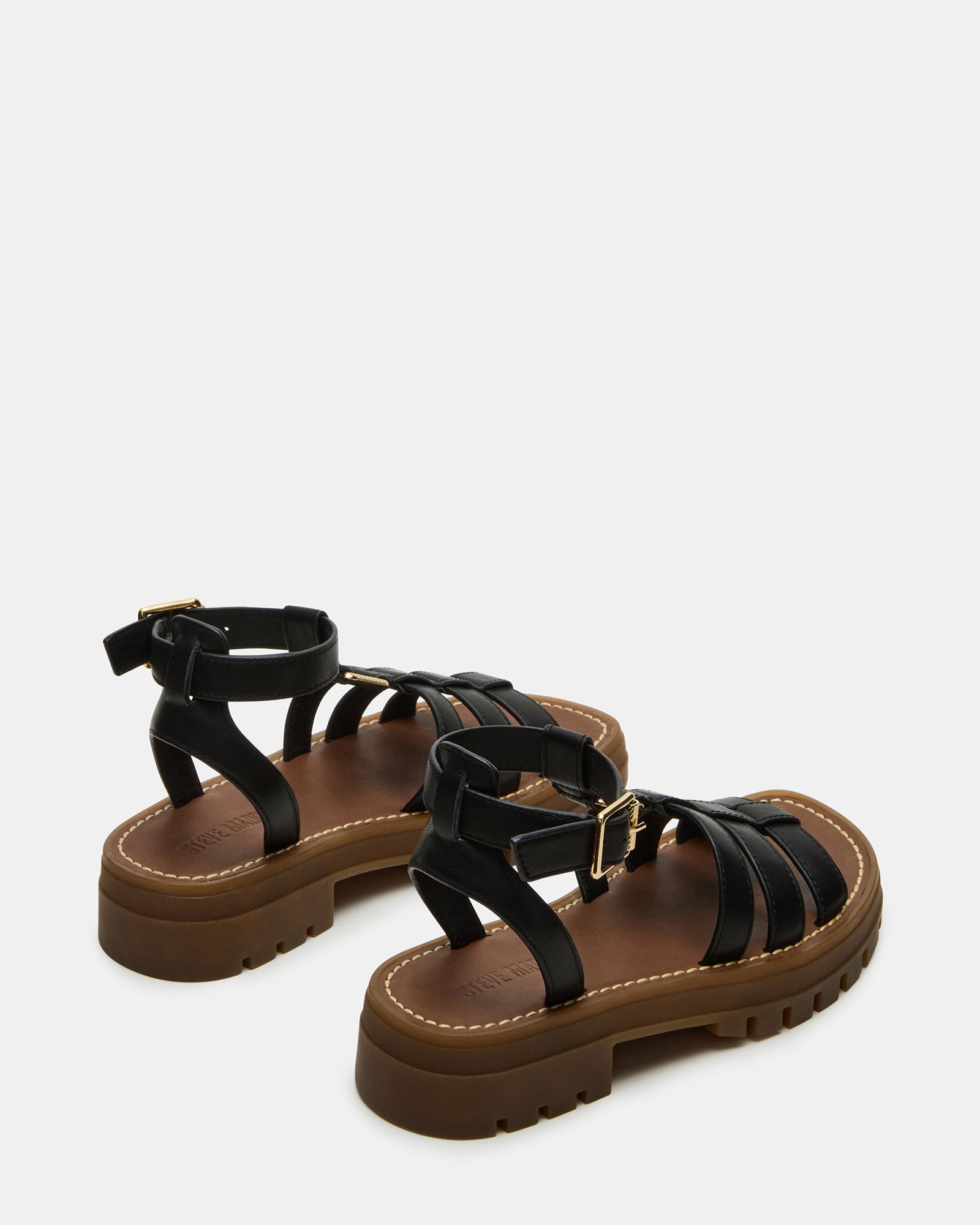Side view of black leather sandals emphasizing the padded insole for comfort.
