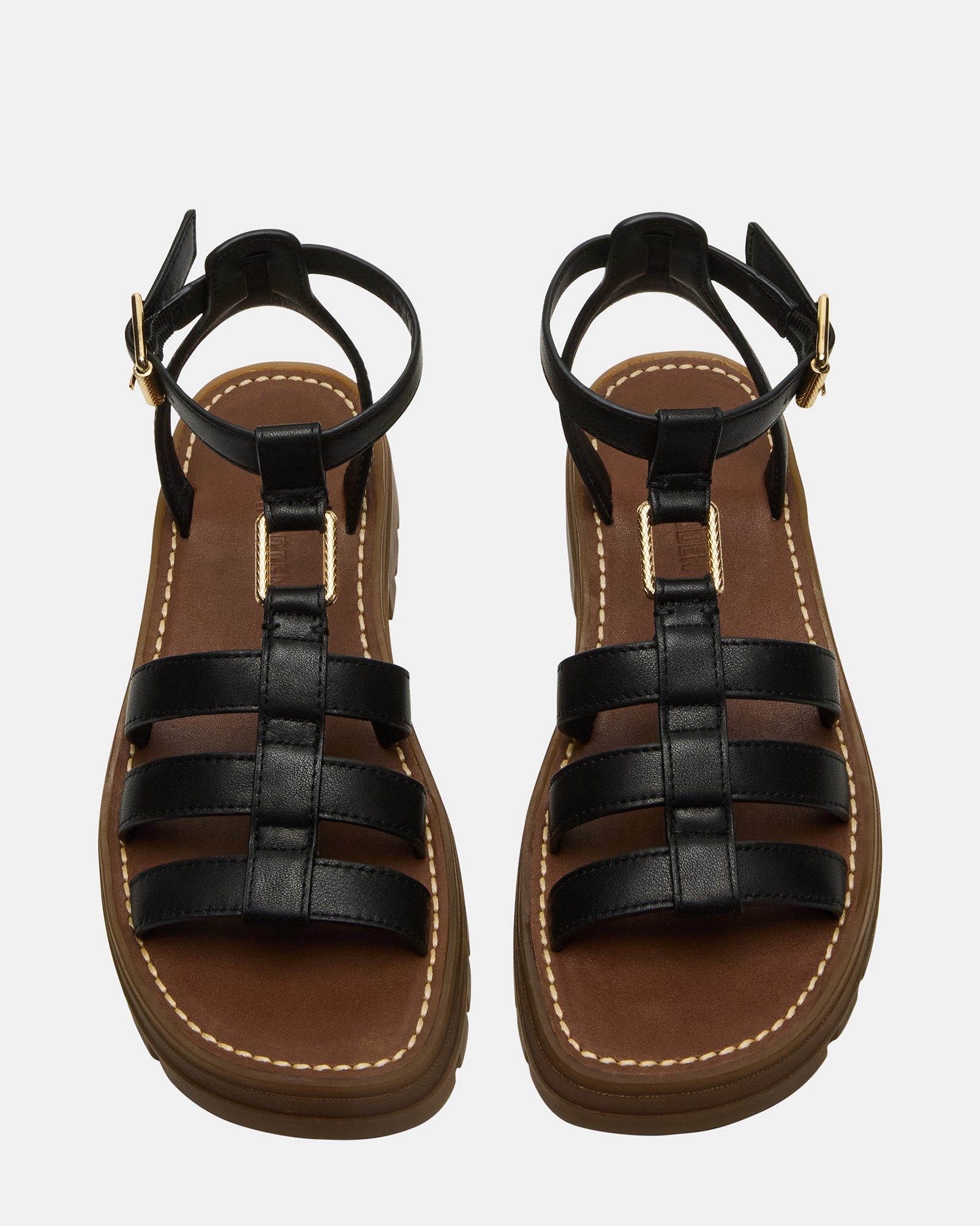 Model wearing black platform sandals during a summer outing, highlighting their versatility.