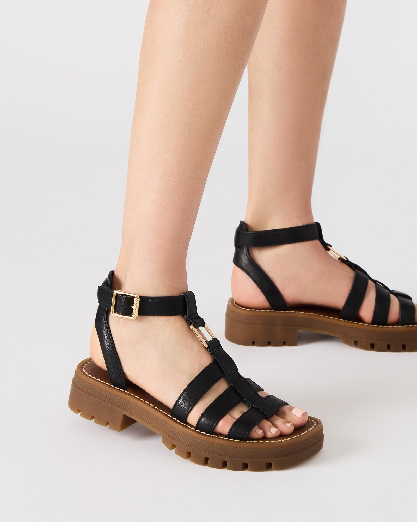 Model wearing black platform sandals during a summer outing, highlighting their versatility.