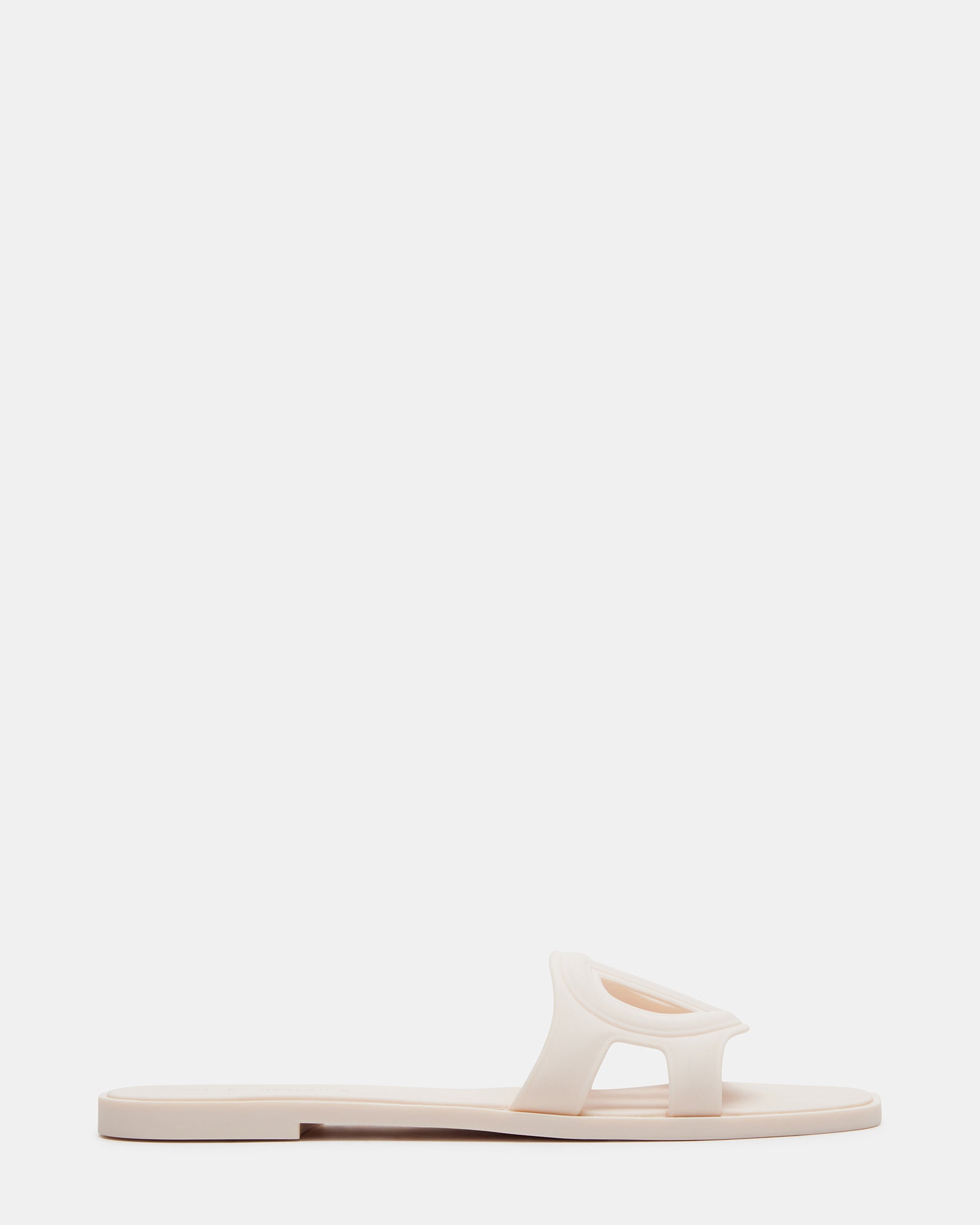 Jellie Bone gold flat sandals paired with a beach towel and sunglasses