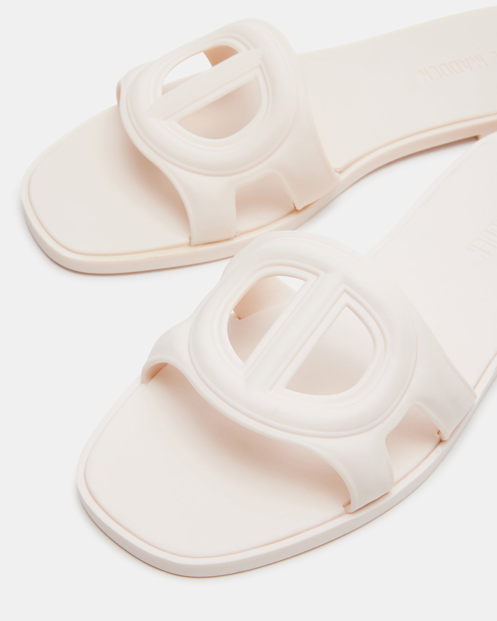 Jellie Bone gold flat sandals paired with a beach towel and sunglasses