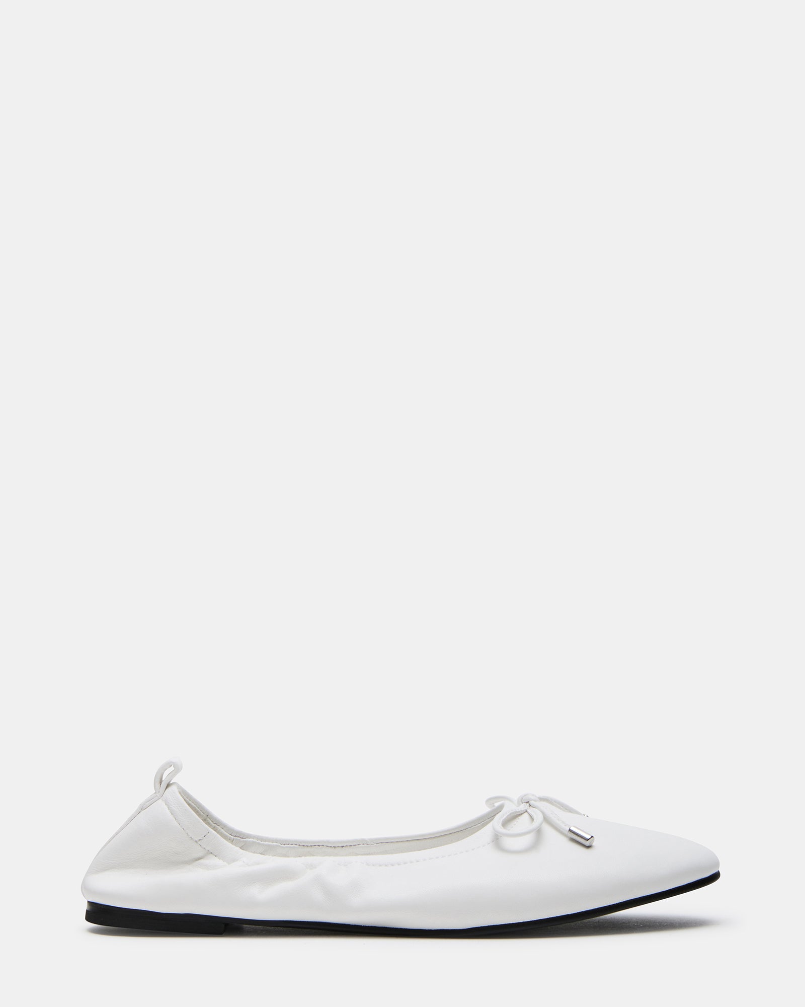Close-up of elegant white leather ballet flats showcasing the delicate bow detail.