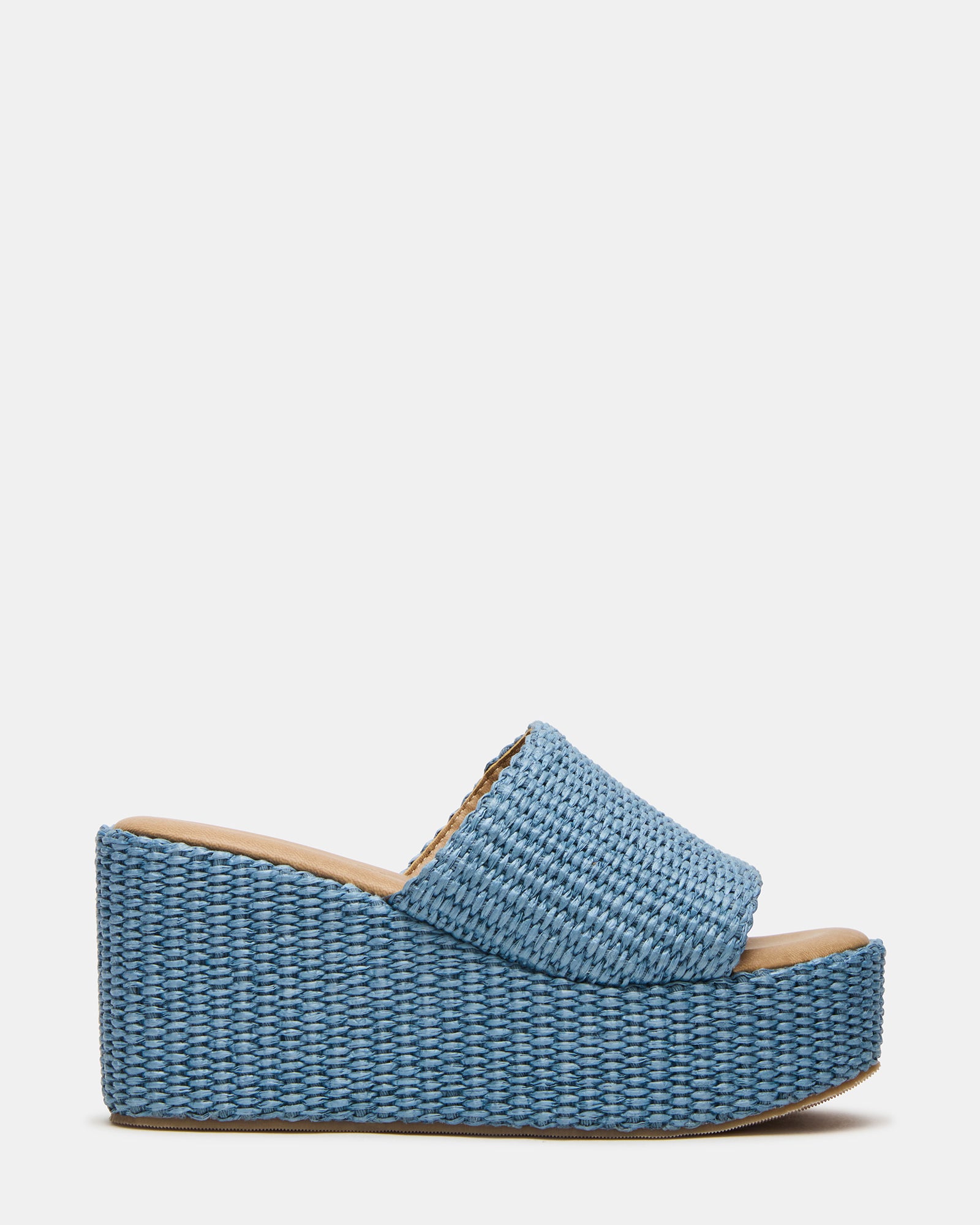 Side view of Jetty Blue raffia wedge sandals on a sunny patio.