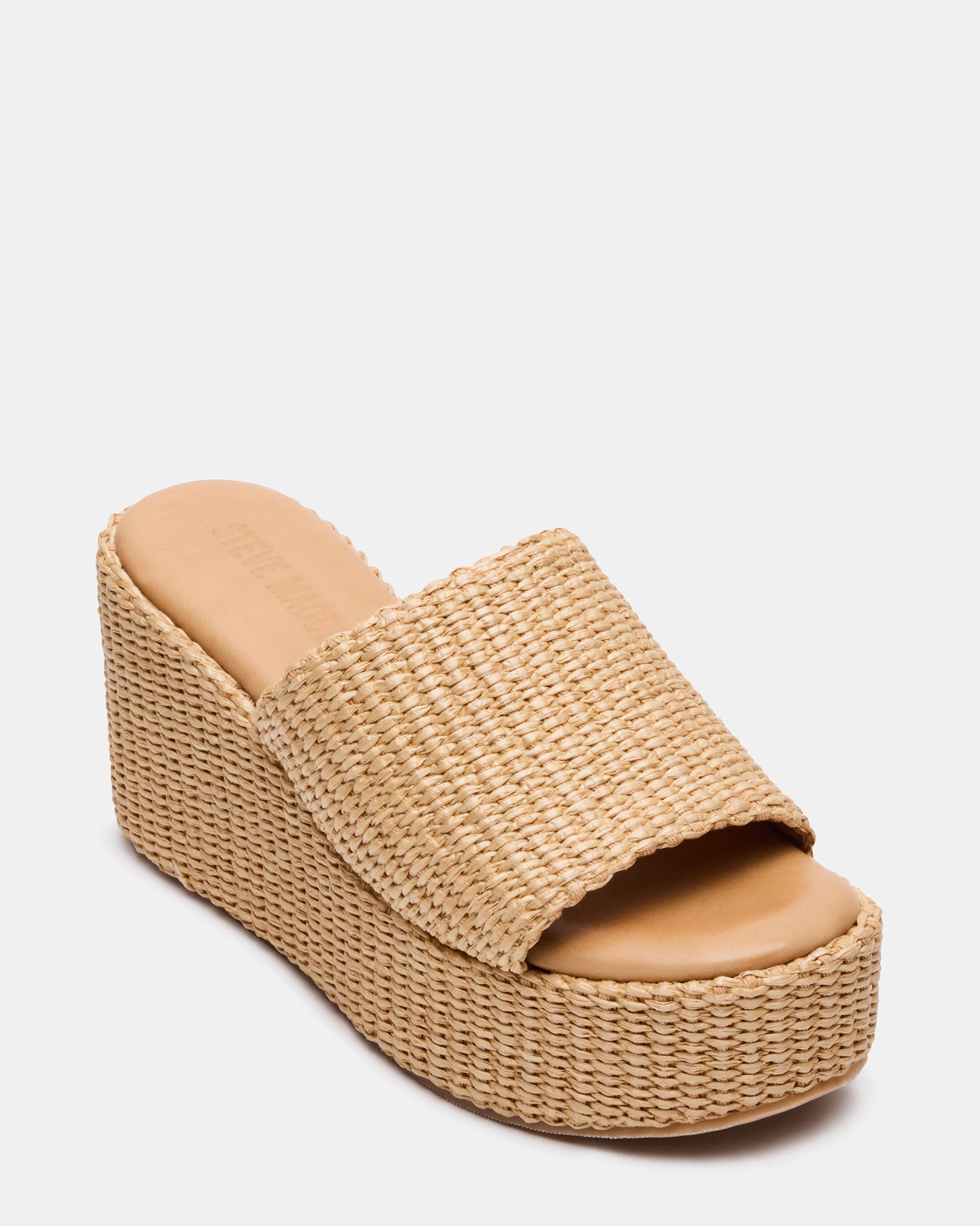 Side view of raffia mule sandal showing the sturdy wedge heel