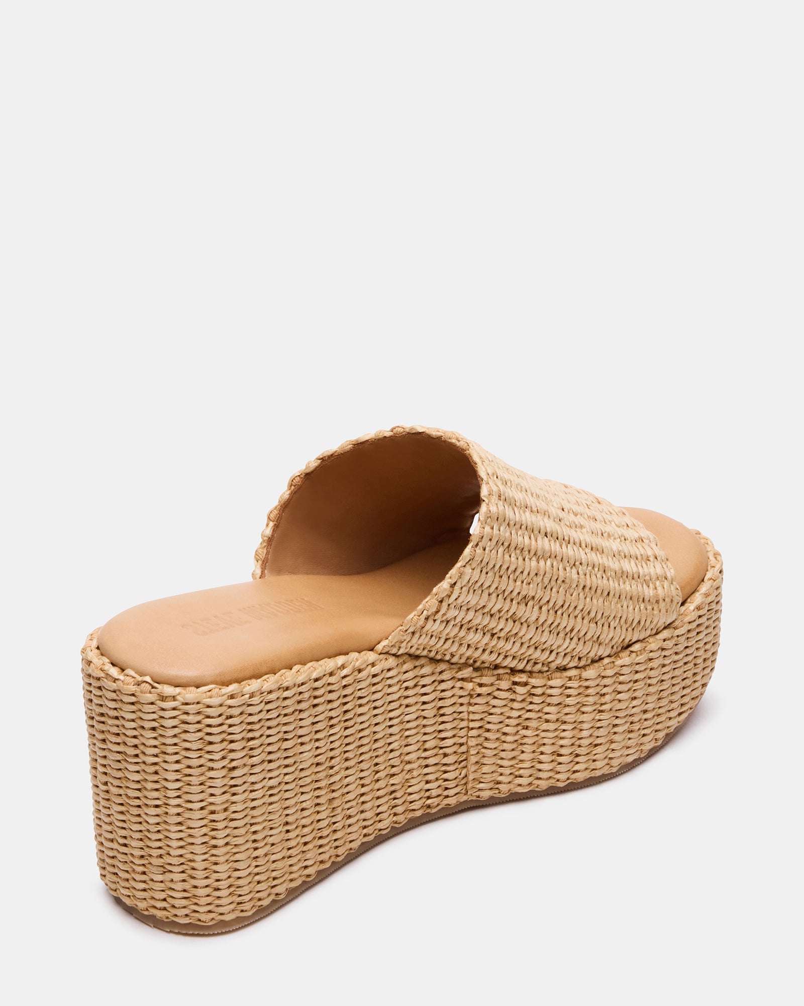 Side view of raffia mule sandal showing the sturdy wedge heel