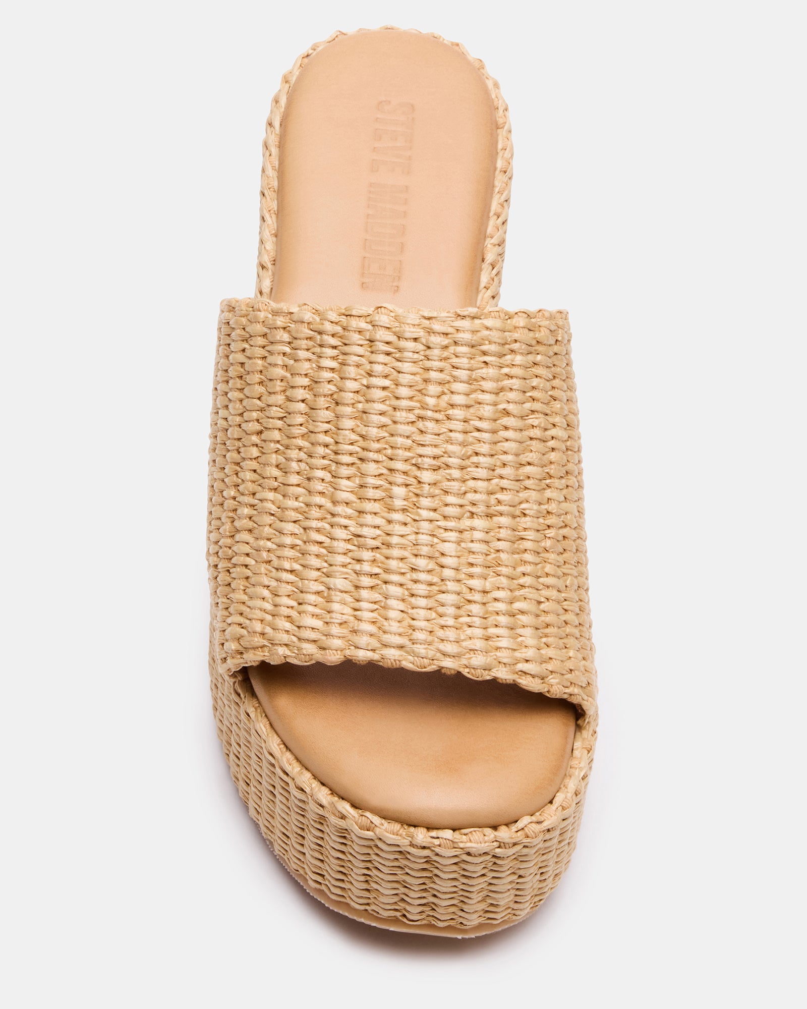 Model wearing raffia wedge sandals with a flowy summer dress