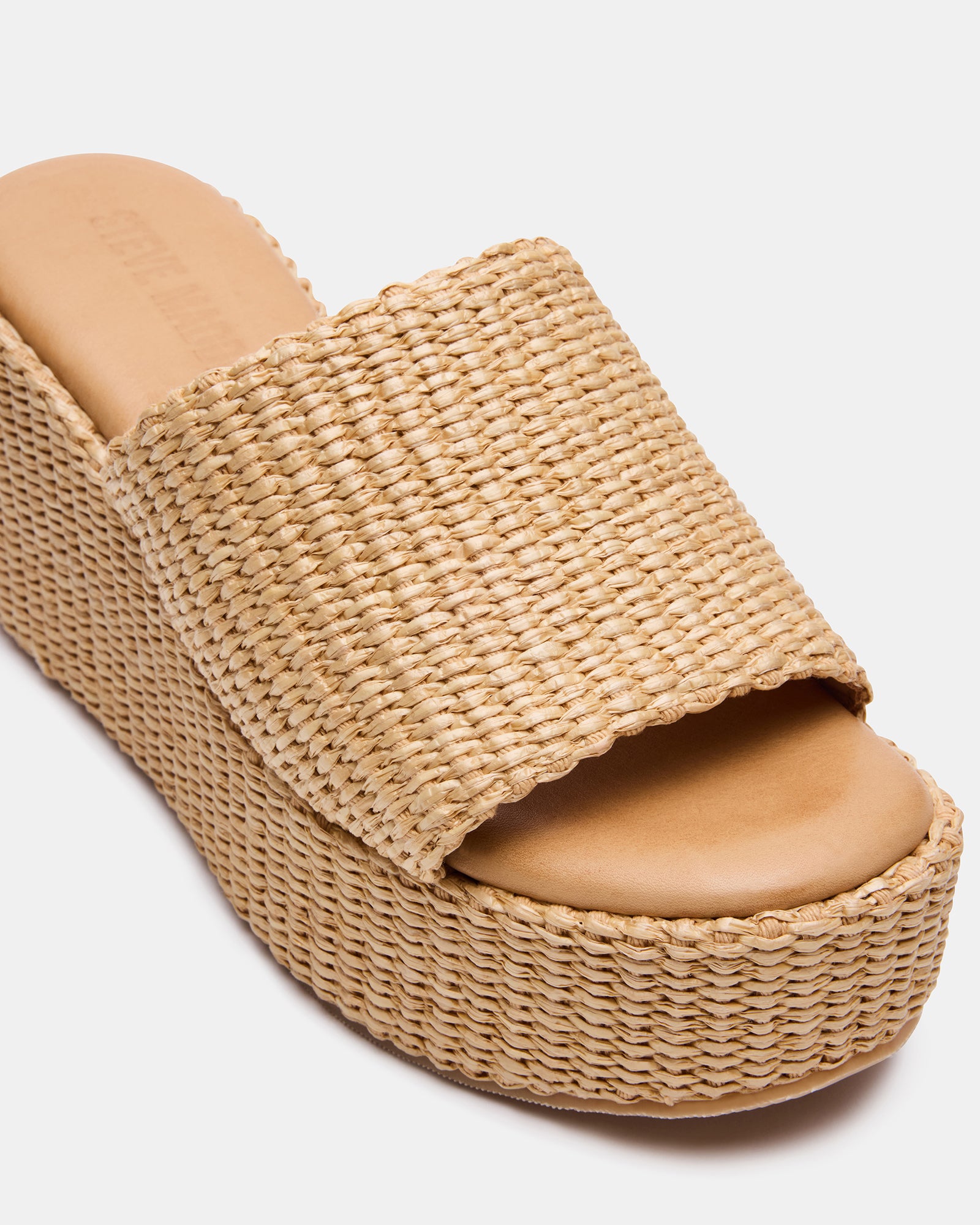 Close-up of raffia platform wedge sandal with natural textured upper