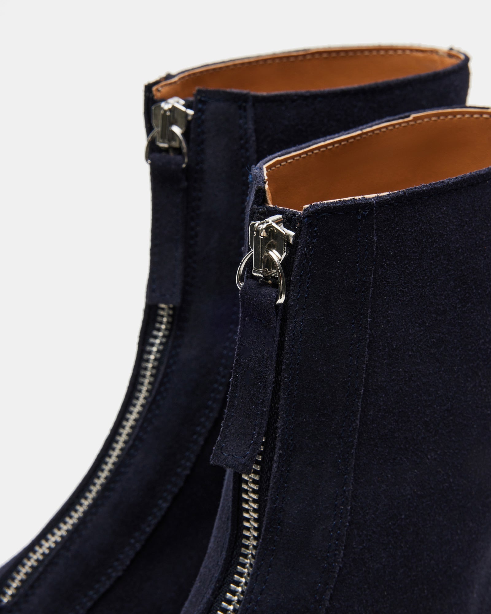 Model wearing navy suede ankle boots paired with casual outfit.