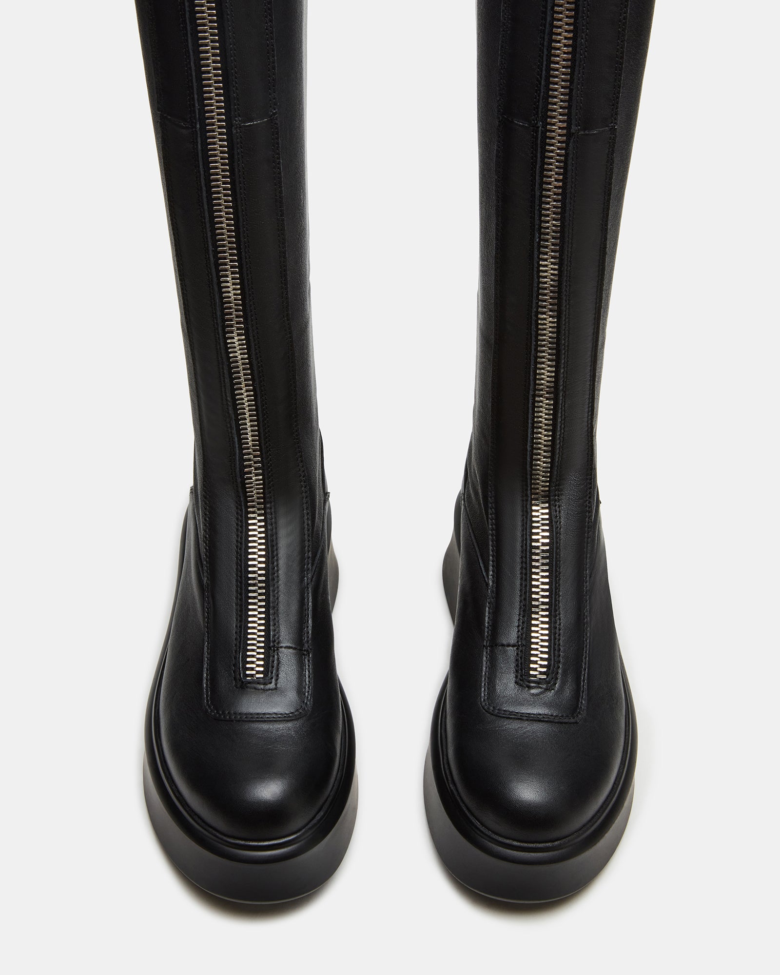 Side view of stylish knee-high black boots with zipper detail.