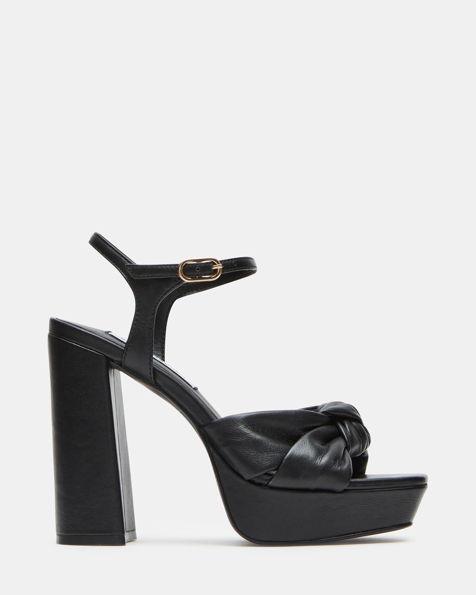 Side view of black patent leather shoes with bow detail on ankle strap