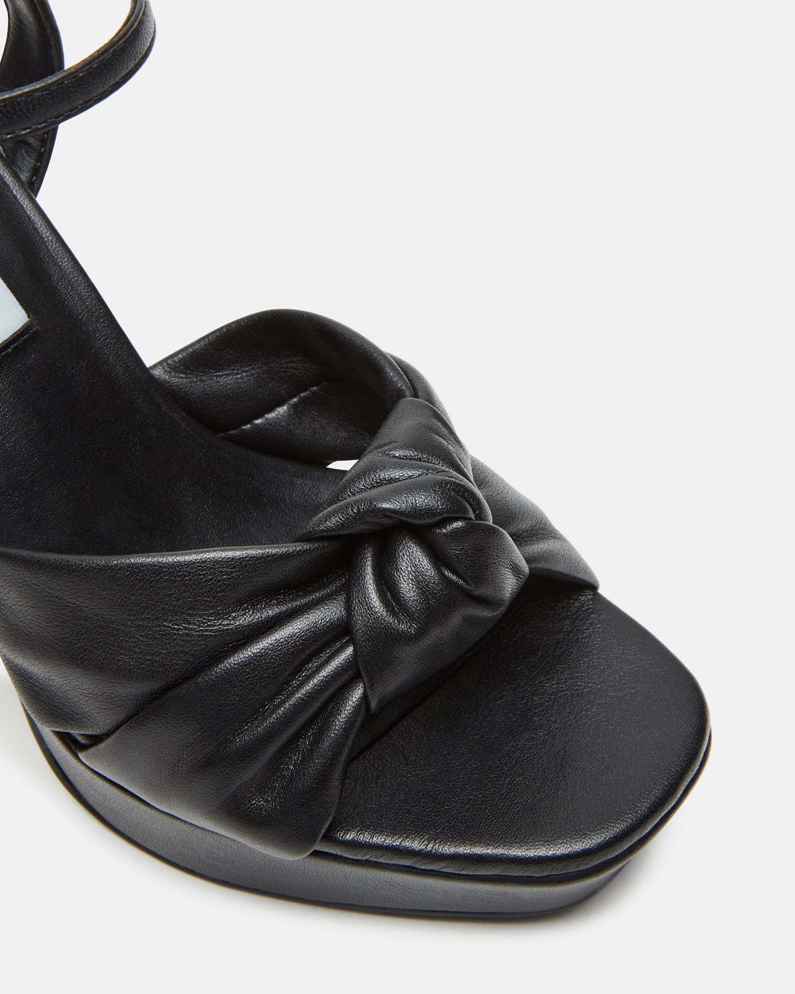 Back view showcasing the elegant ankle strap and heel height