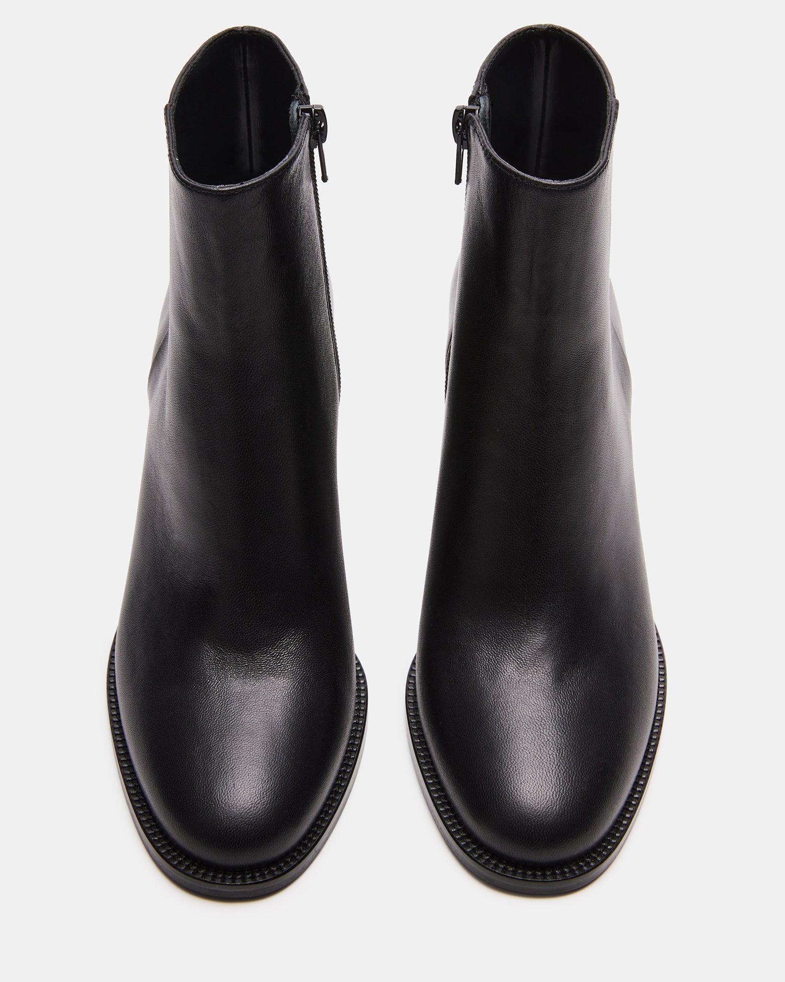 Side view of the block heel bootie, highlighting its polished finish.