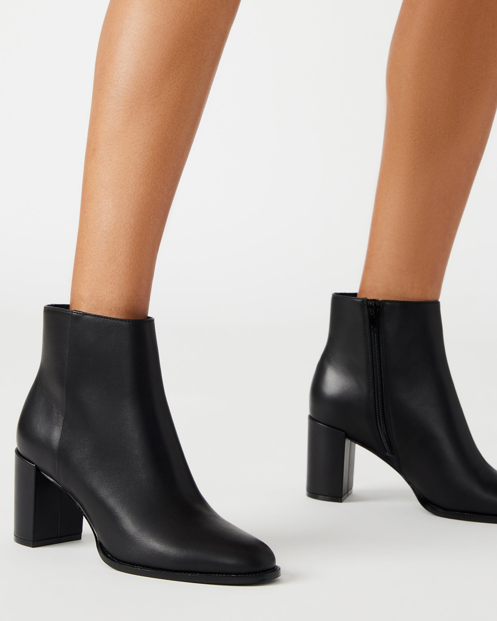Side view of the block heel bootie, highlighting its polished finish.