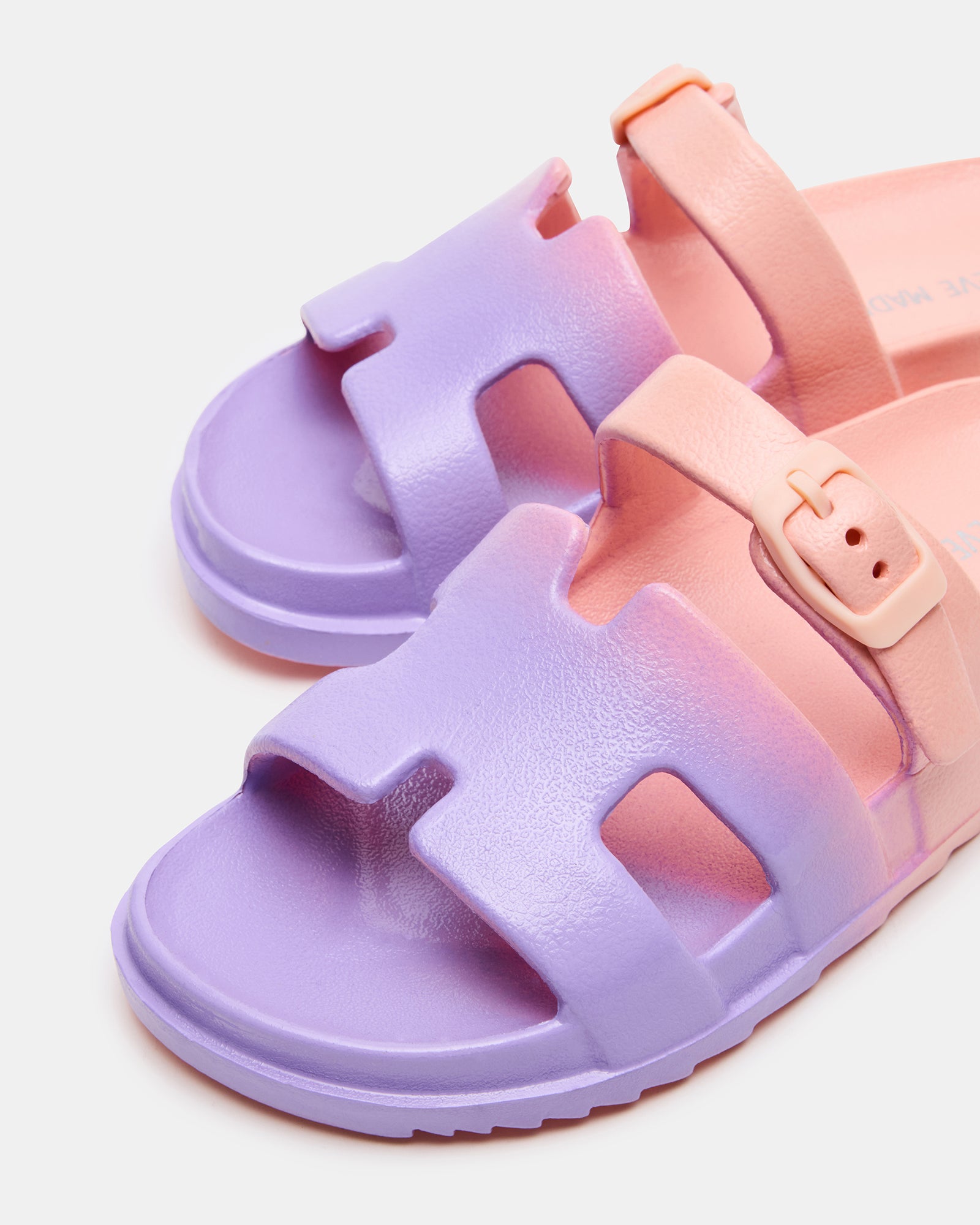 Child wearing the sandals outdoors, highlighting the easy slide-on style.