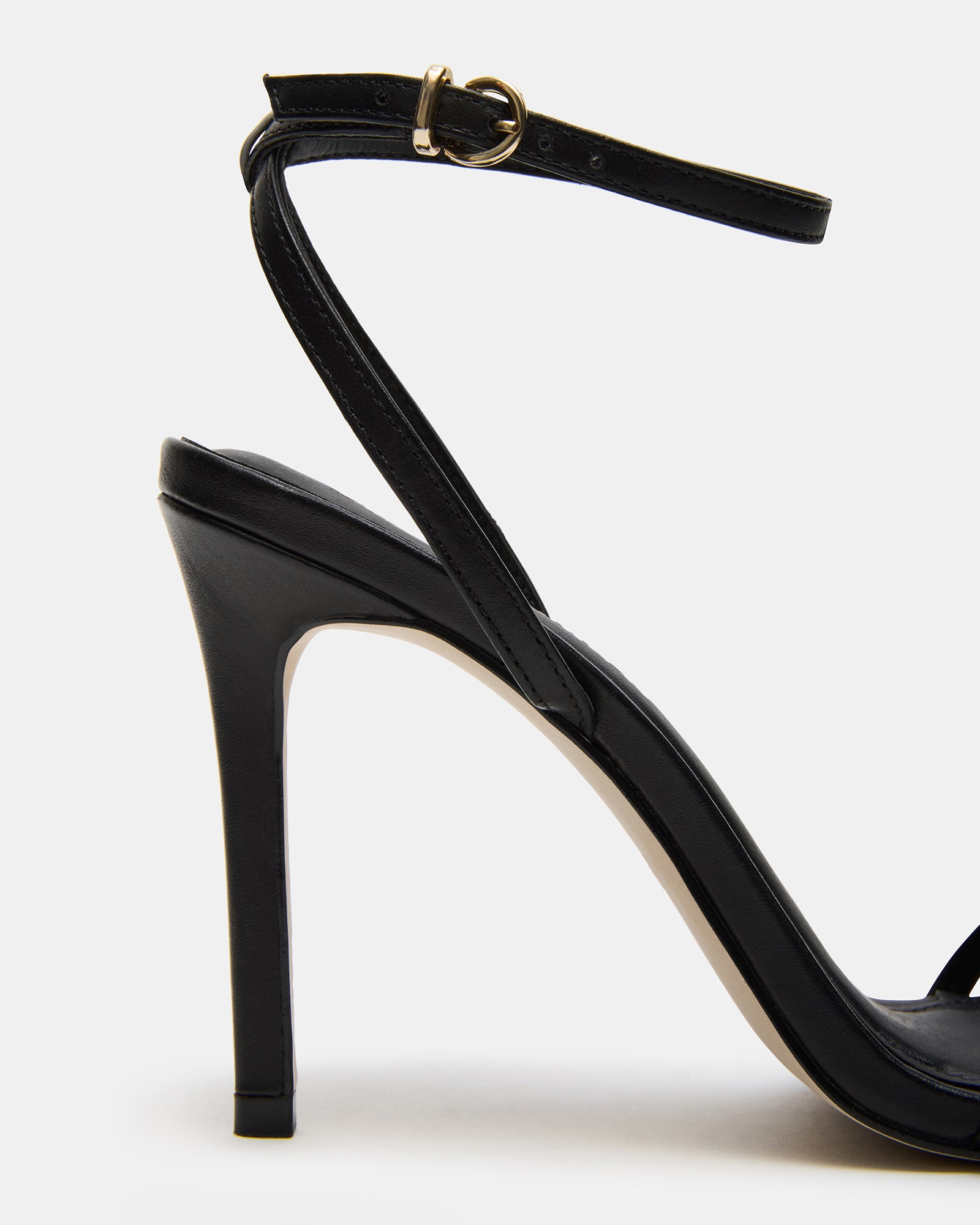 Side view of black leather high heels with ankle strap and stiletto heel