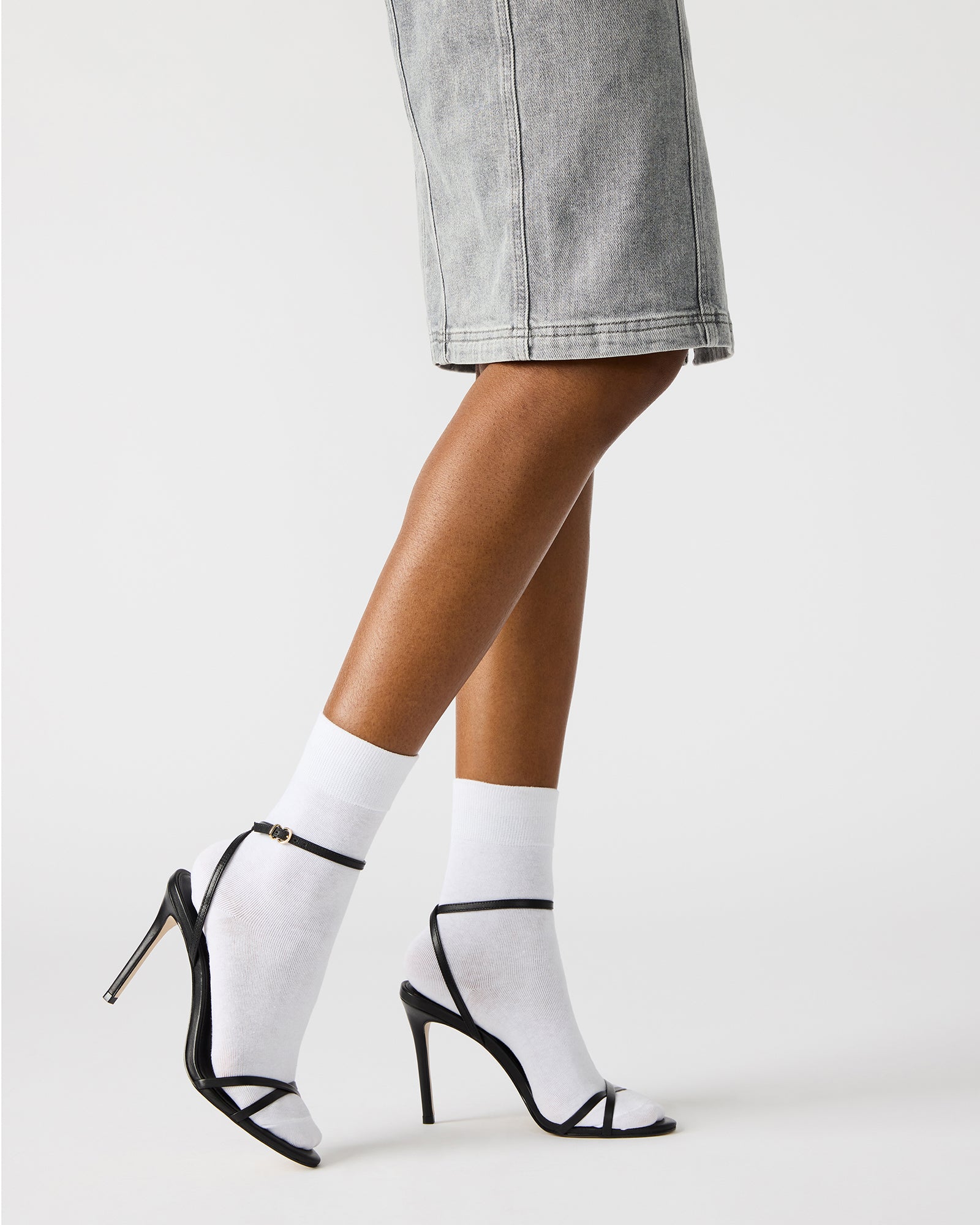 Close-up of the crisscross back detail on black leather heels