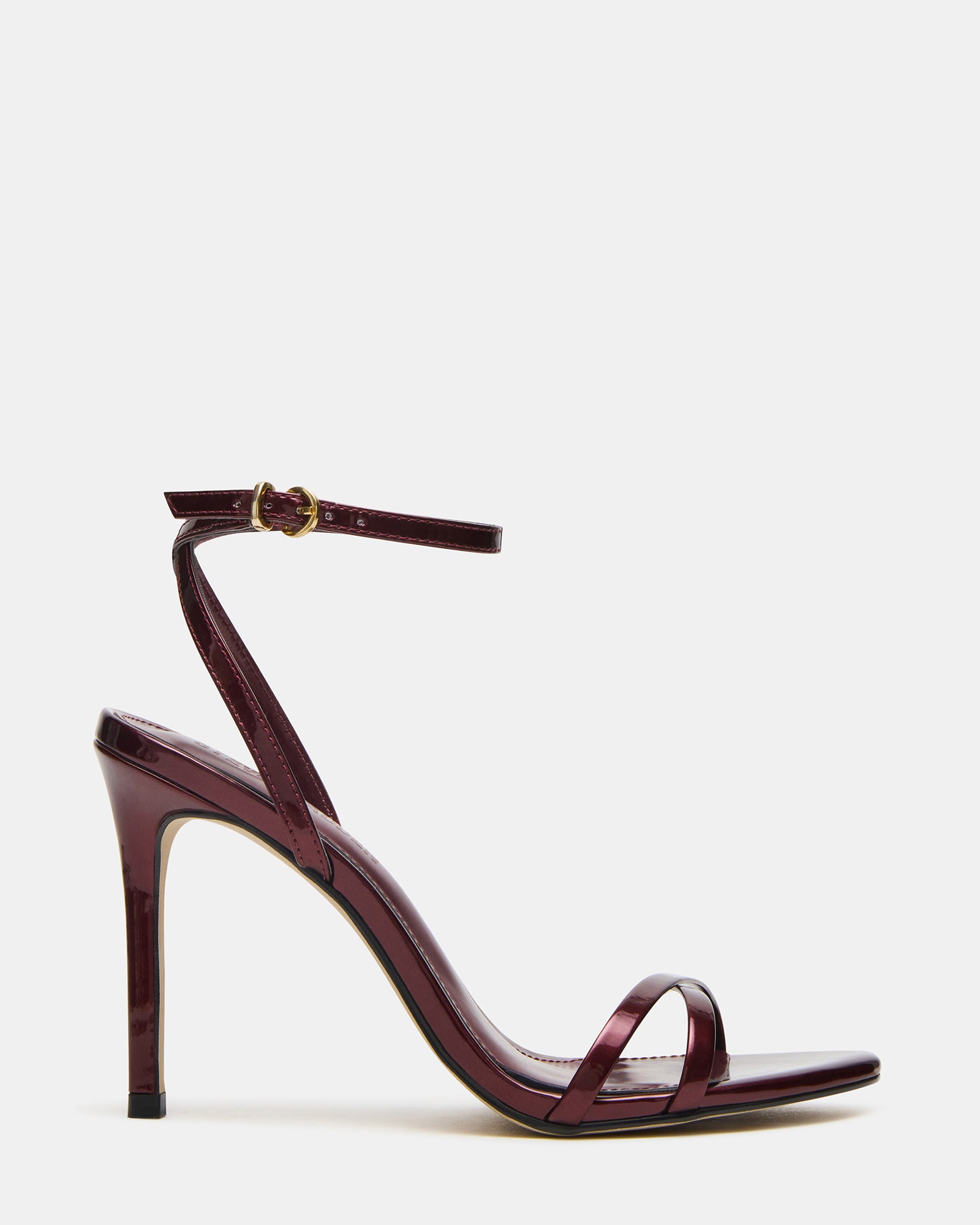 Gold JYPSY stiletto heels on hardwood floor, showcasing ankle strap