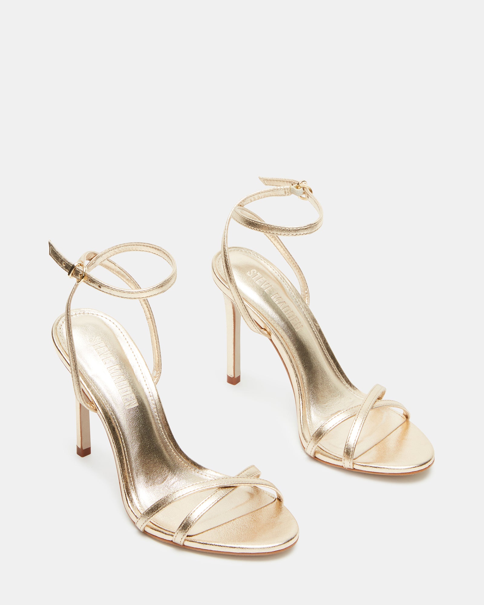Gold stiletto heels paired with evening dress