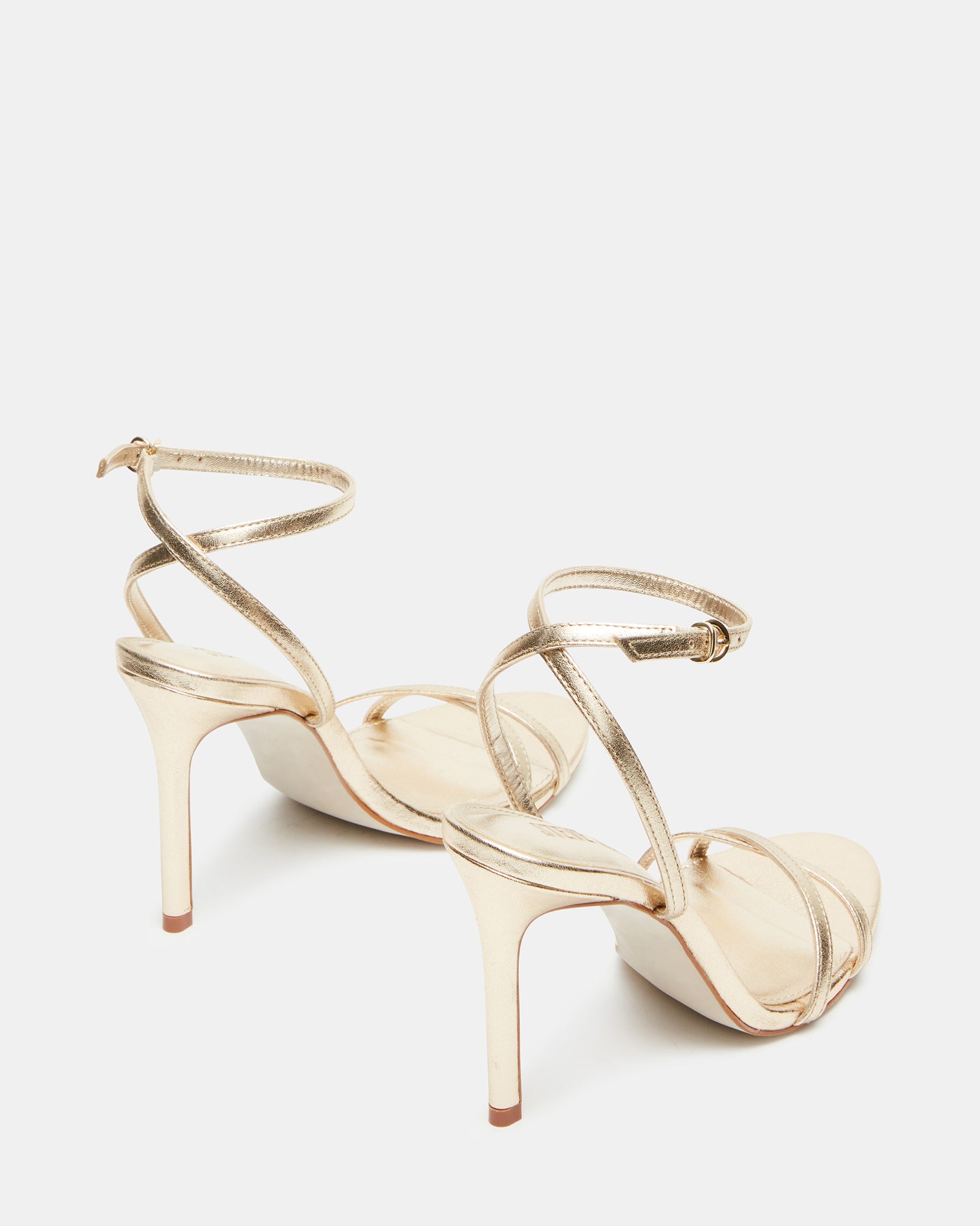 Gold stiletto heels paired with evening dress