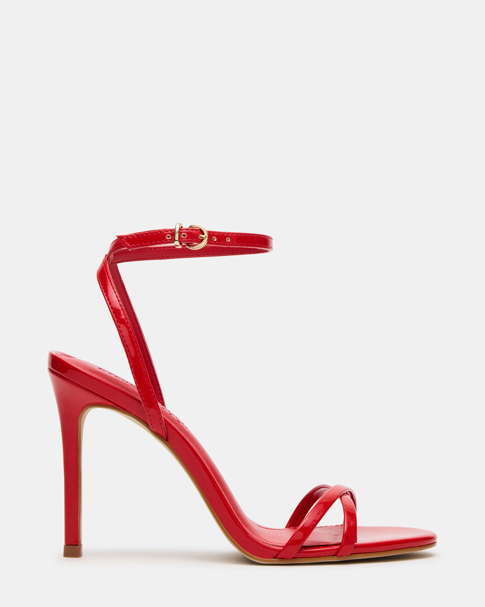 Close-up of red patent leather high heels showing strappy detail