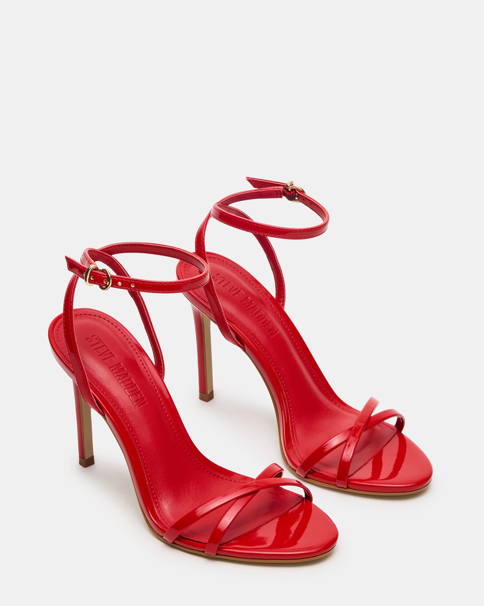 Side view of red patent platform heels with stiletto heel