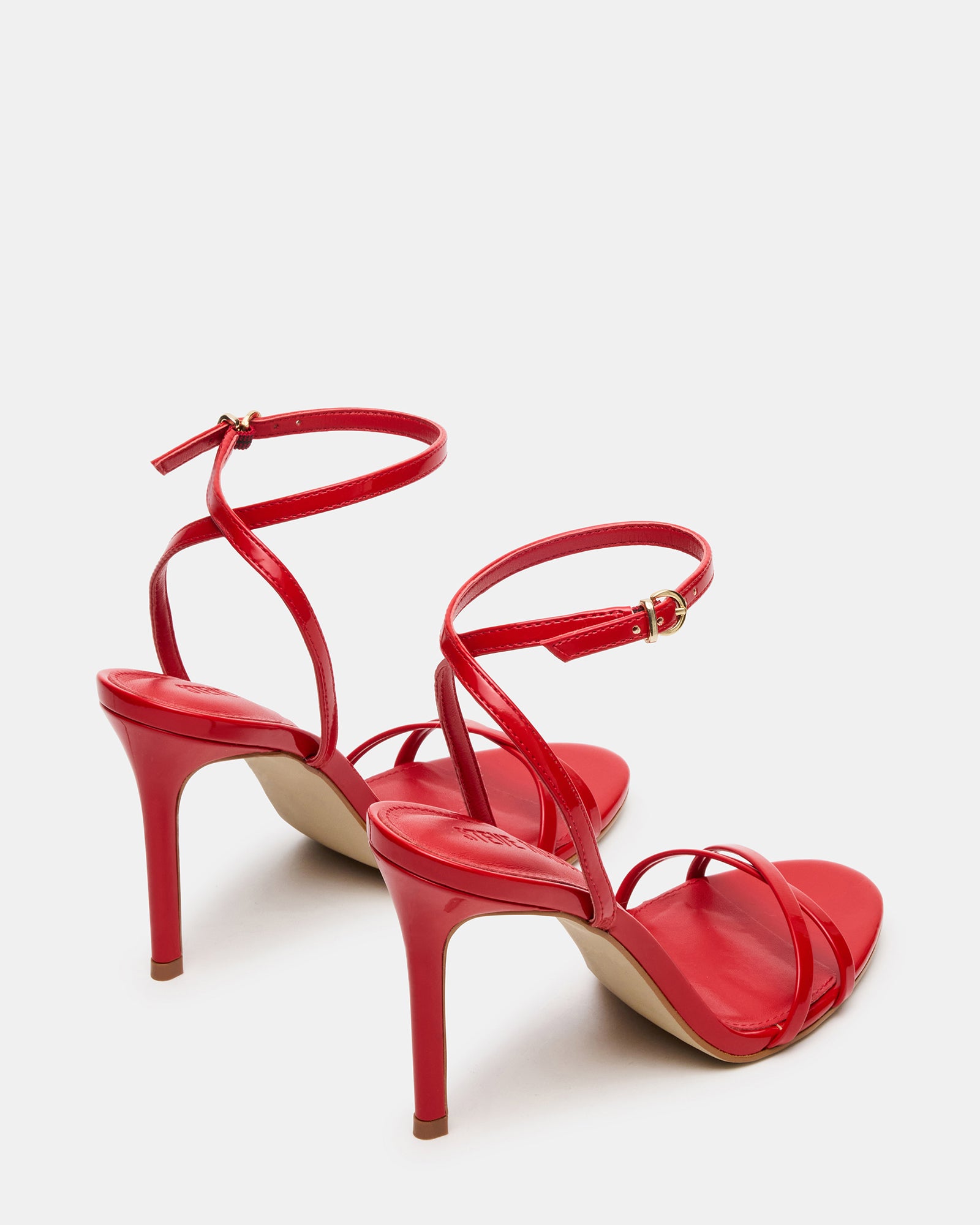 Side view of red patent platform heels with stiletto heel