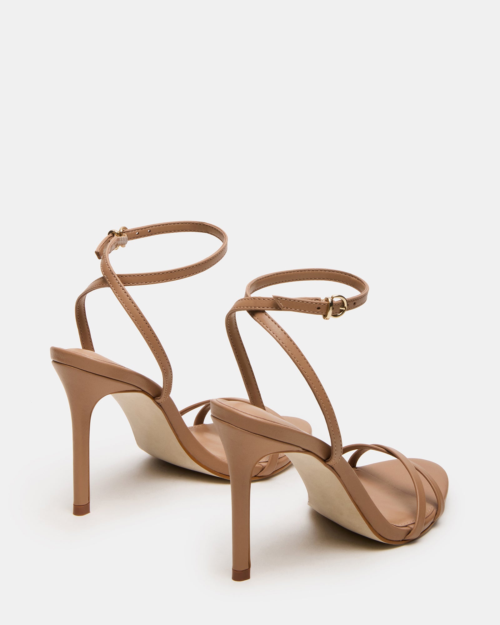 Close-up of the rounded toe and crisscross back of the tan stiletto heels.