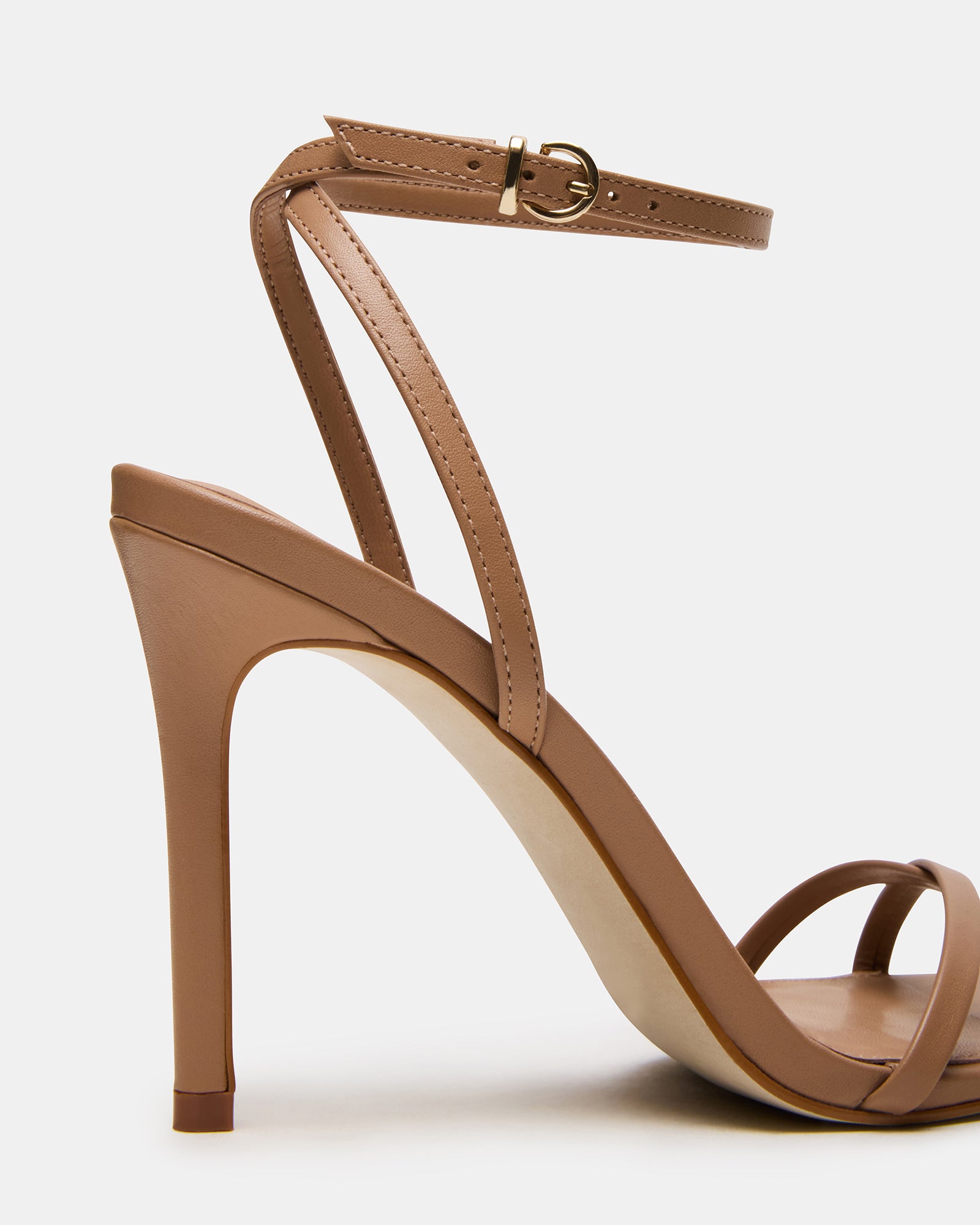 Elegant tan leather stiletto heels showcasing the strappy design and ankle strap.