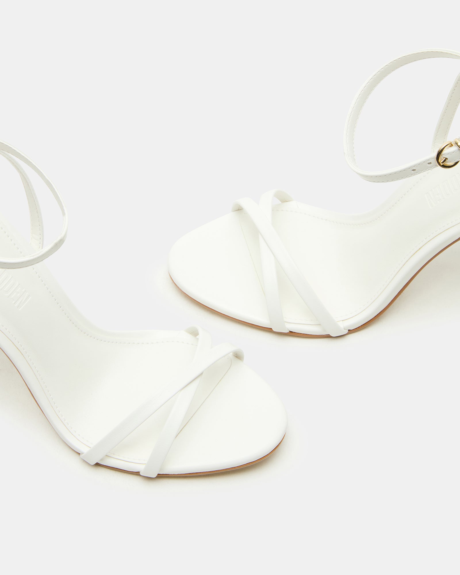 JYPSEY white leather stiletto heels front view, showcasing strappy design