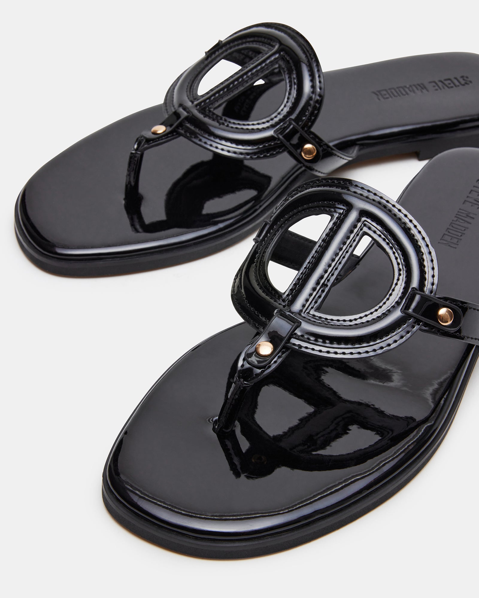 Side view of the KADE black patent thong sandals showing the stylish design and heel