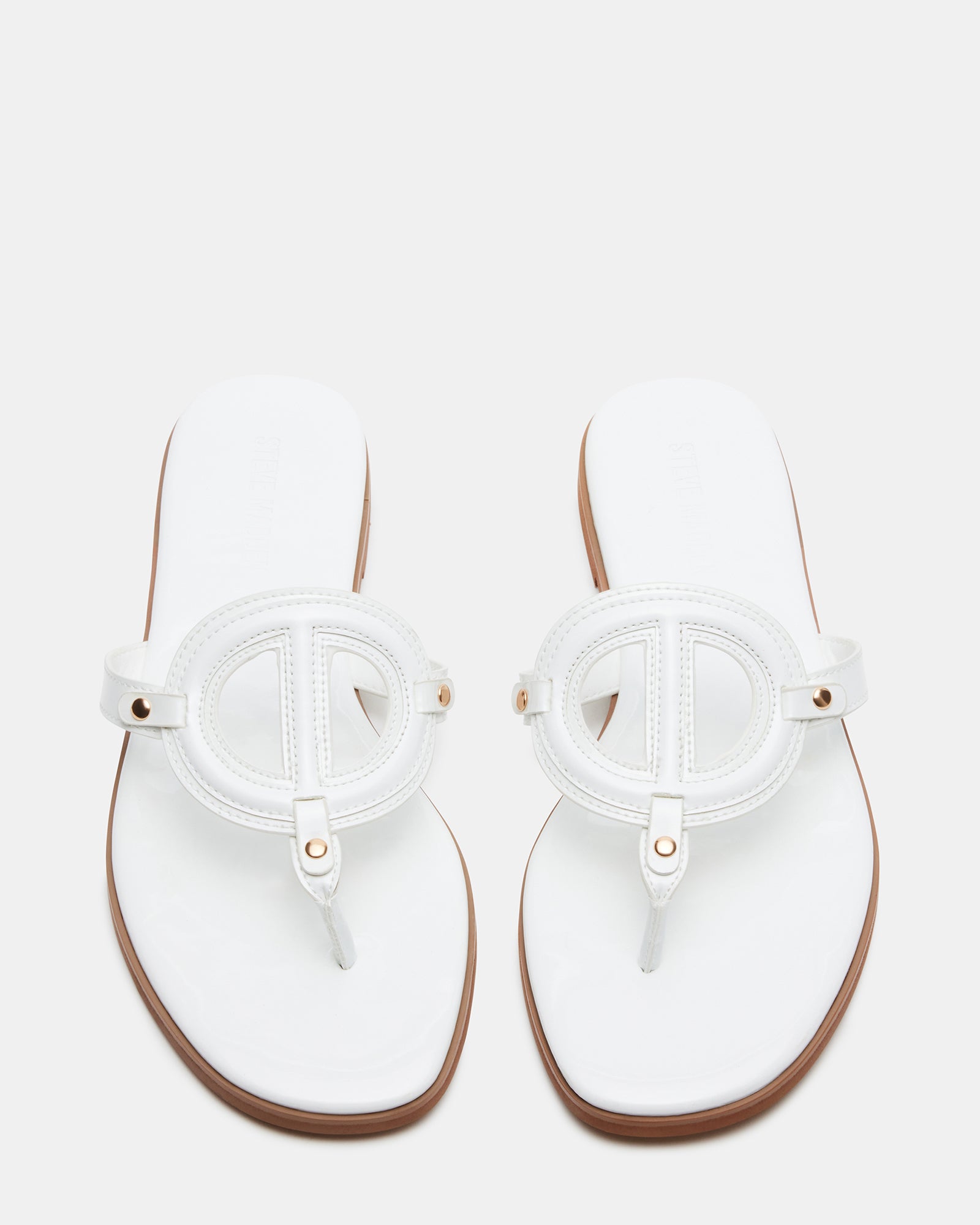 Front view of KADE white patent thong sandals highlighting the sleek design
