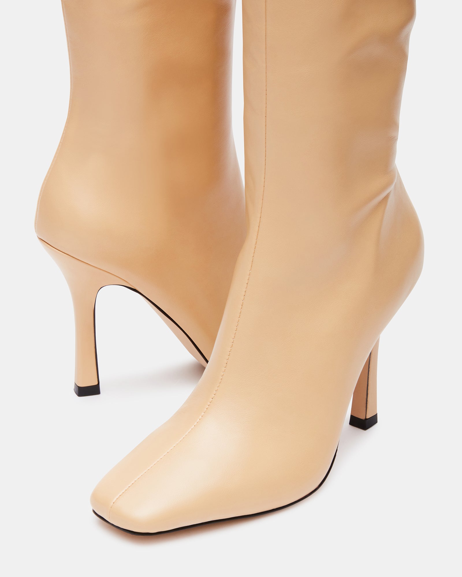 Close-up of the stretch gore and side zipper on the knee high boots